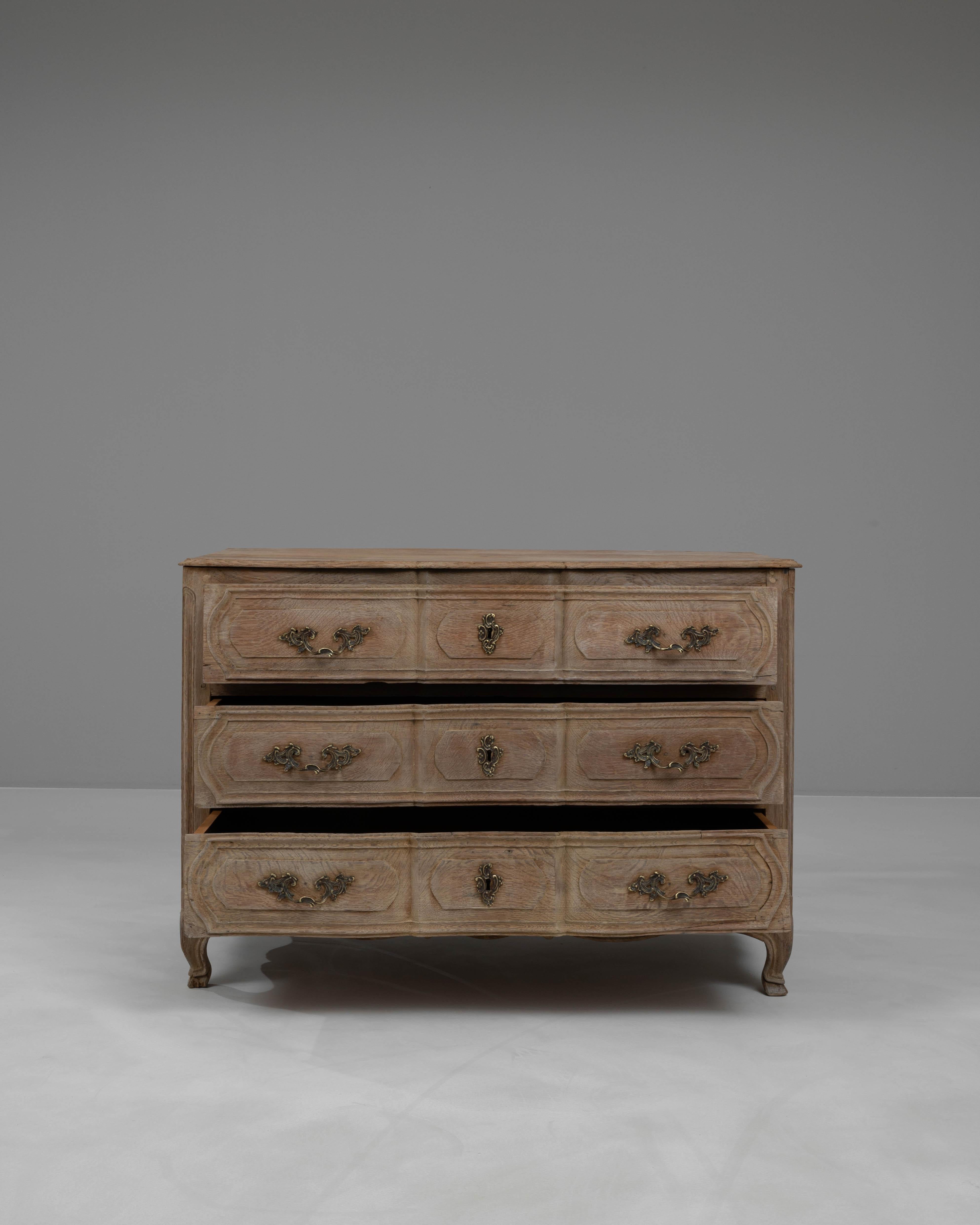Add a touch of classic French elegance to your home with this 19th Century French Bleached Oak Chest of Drawers. Beautifully crafted from solid oak, this piece has been meticulously bleached to highlight the wood's natural grain and texture.