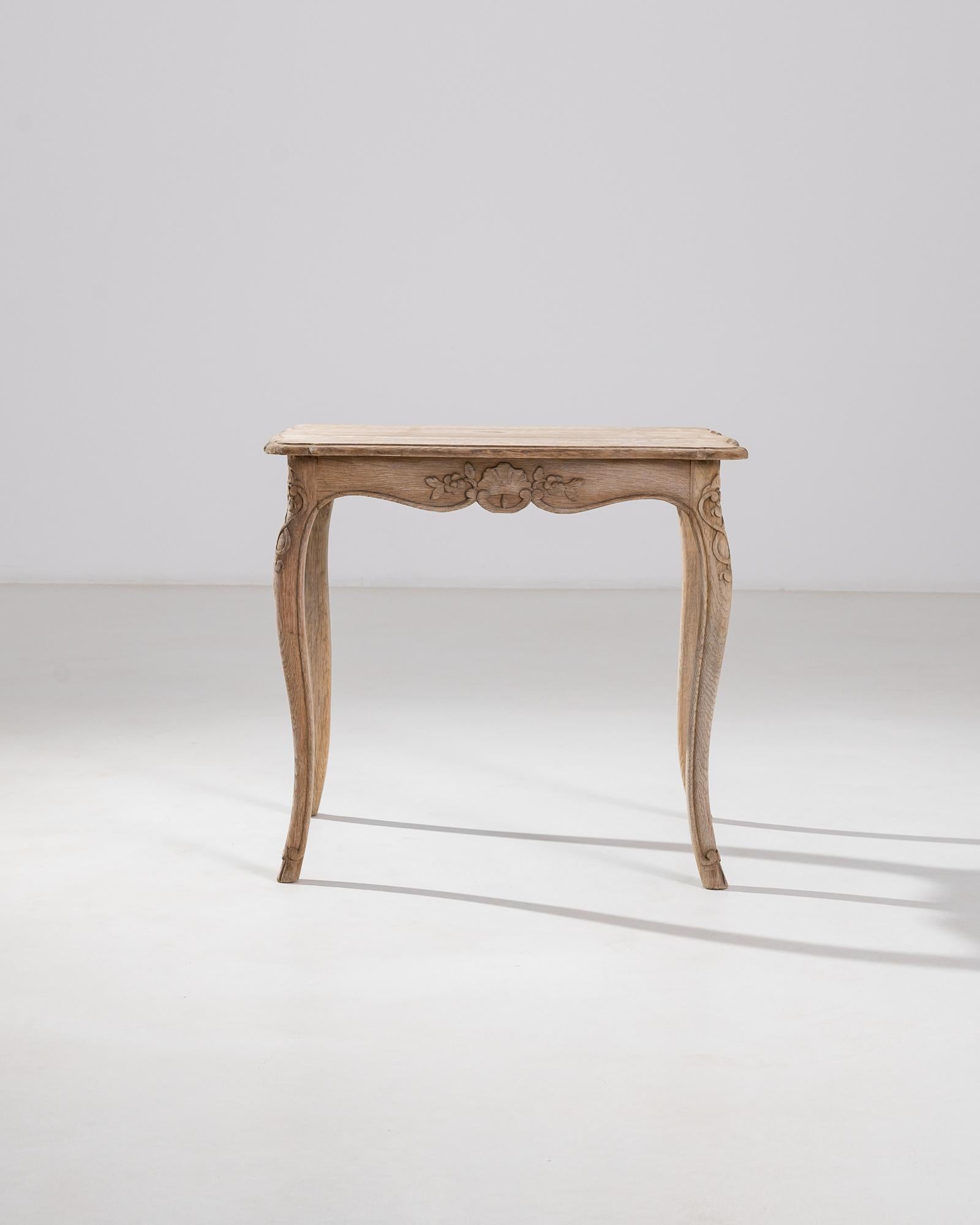 Discover the charm of a bygone era with this 19th Century French Bleached Oak Side Table. Each glance reveals the table's rich history and the artisanship of its creators. The beautifully weathered oak surface boasts a soft, sun-kissed patina that