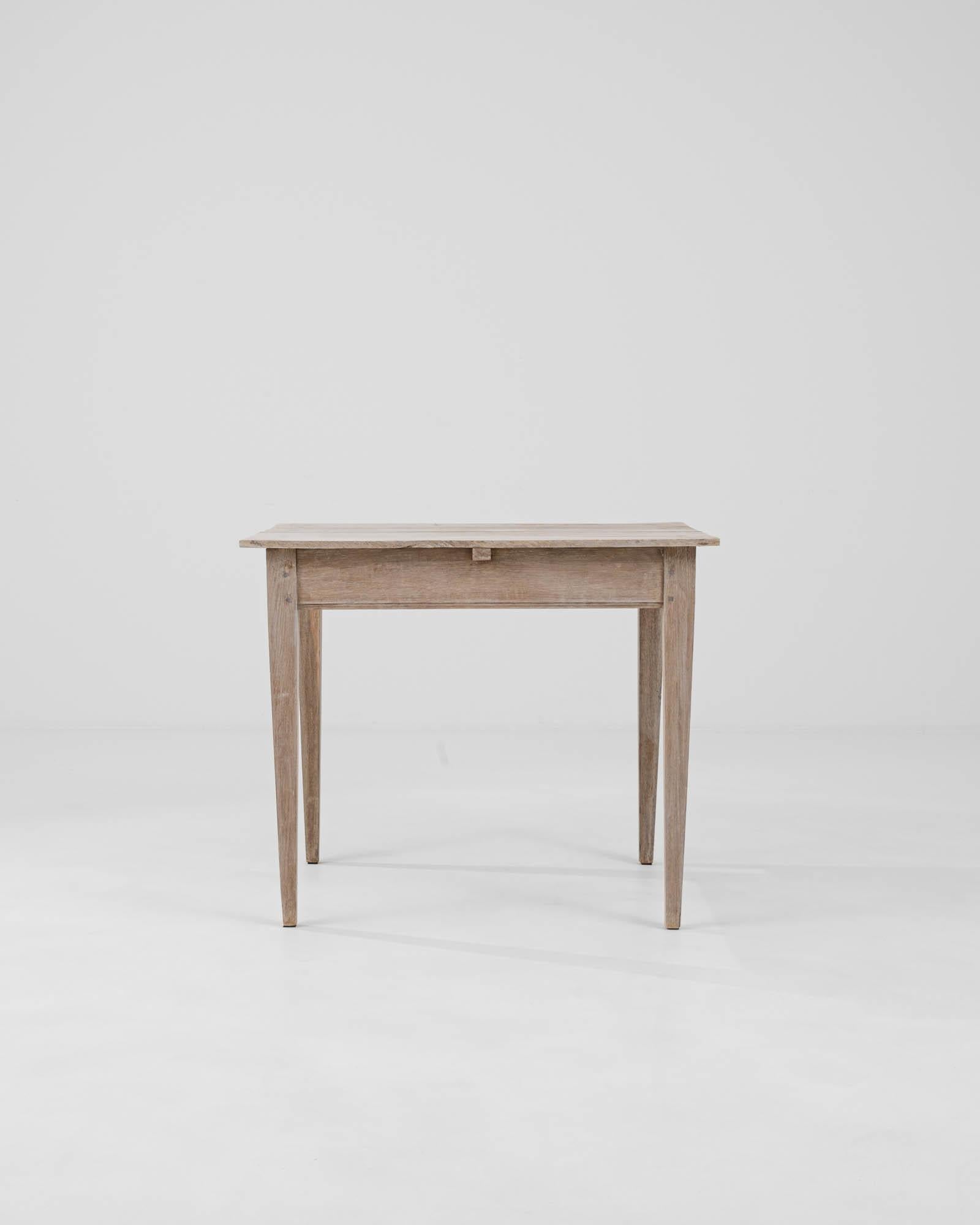 Step into the charm of the French countryside with this authentic 19th Century French Bleached Oak Side Table. This piece captures the essence of rustic elegance, with its naturally weathered finish and simple, clean lines that evoke a sense of calm