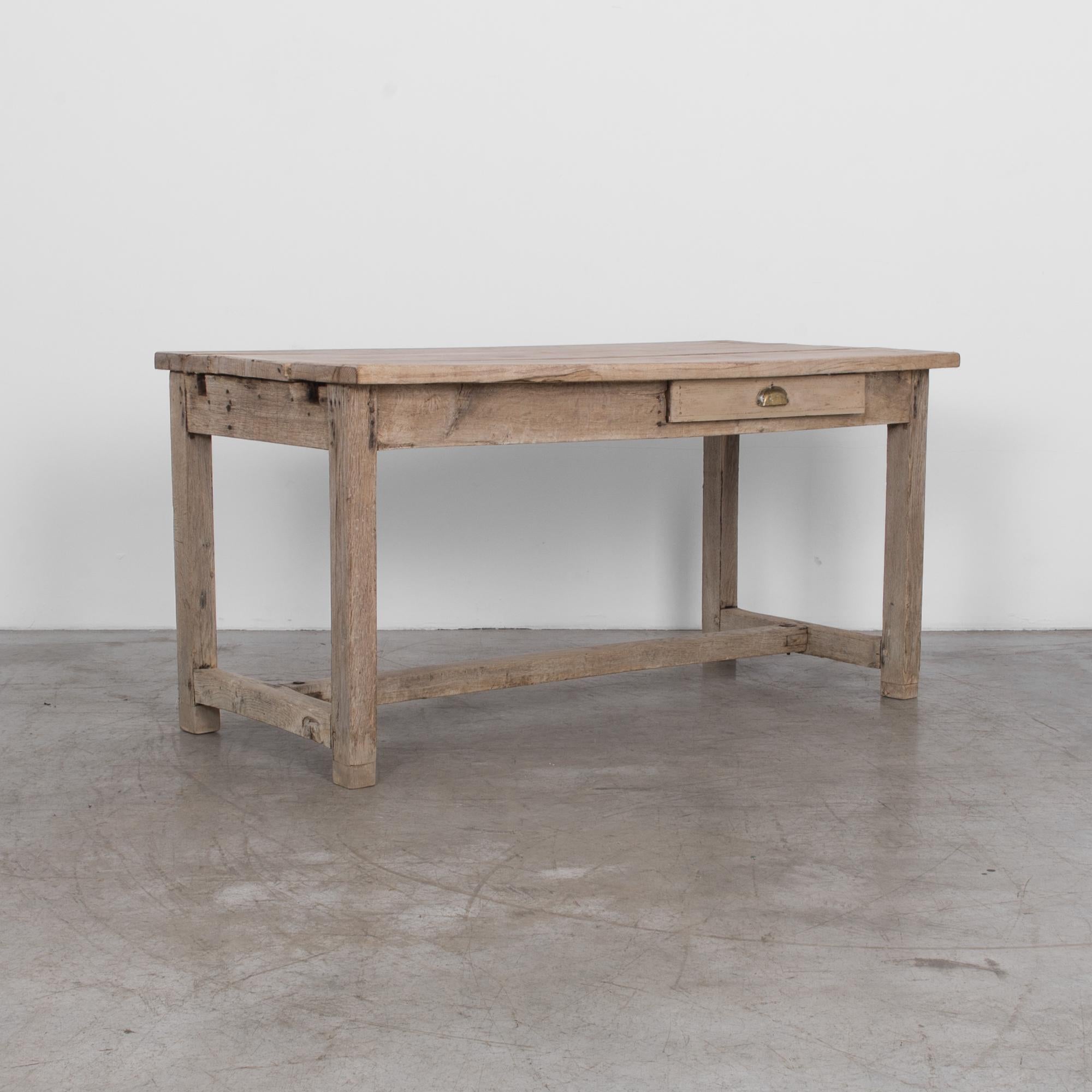 Simple and rustic table made from solid oak, cleaned and finished with a nourishing natural oil. From late 19th century France, this table is has a storied past, and a long future; made from the highest-quality materials, and traditional