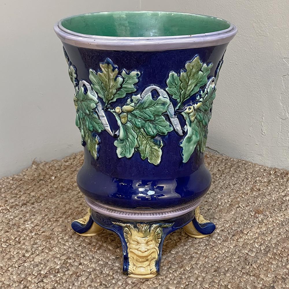 19th century French blue Barbotine Jardiniere with stand is a colorful and vibrant example of the amazing pottery that emanated from northern France over the past several centuries. Cast in a classic form, the bottom bells out slightly according to