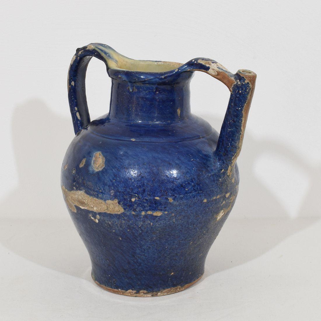 Great authentic and extremely rare piece of pottery with a spout in handle from the Provence. Beautiful weathered and an amazing and almost impossible to find blue color. Imperfections help authenticate this water cruche as it was a utilitarian type