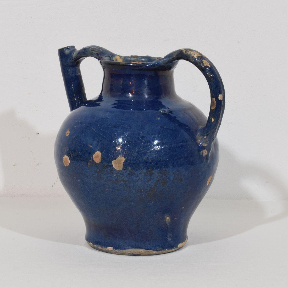 Great authentic and extremely rare piece of pottery with a spout in handle from the Provence. Beautiful weathered and an amazing and almost impossible to find blue color. Imperfections help authenticate this water cruche as it was a utilitarian type