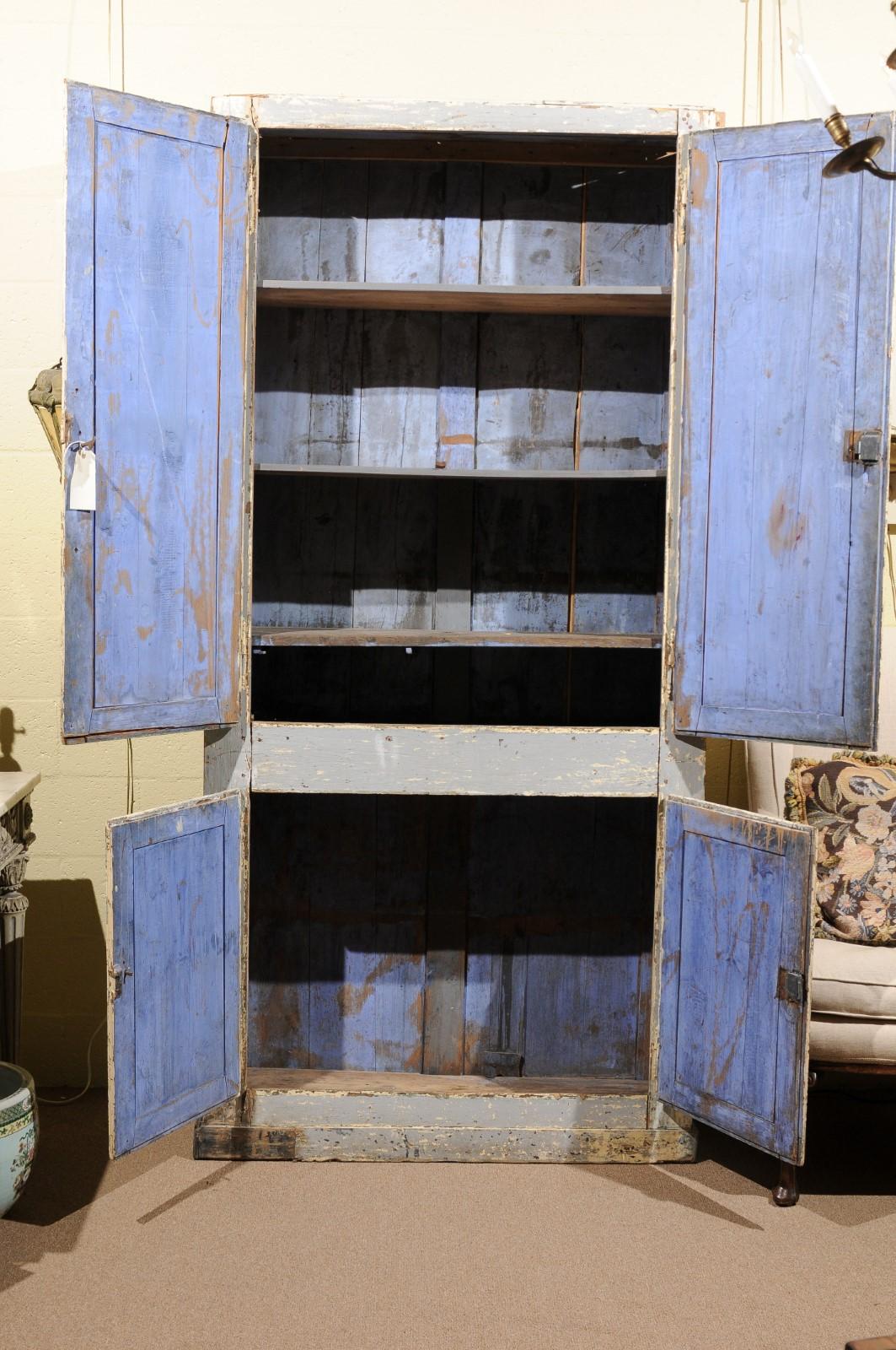 Light blue painted cabinet / armoire with 4 cabinet doors and azure blue painted interior, 19th century France. Upper cabinets fitted with shelves. No cornice available.