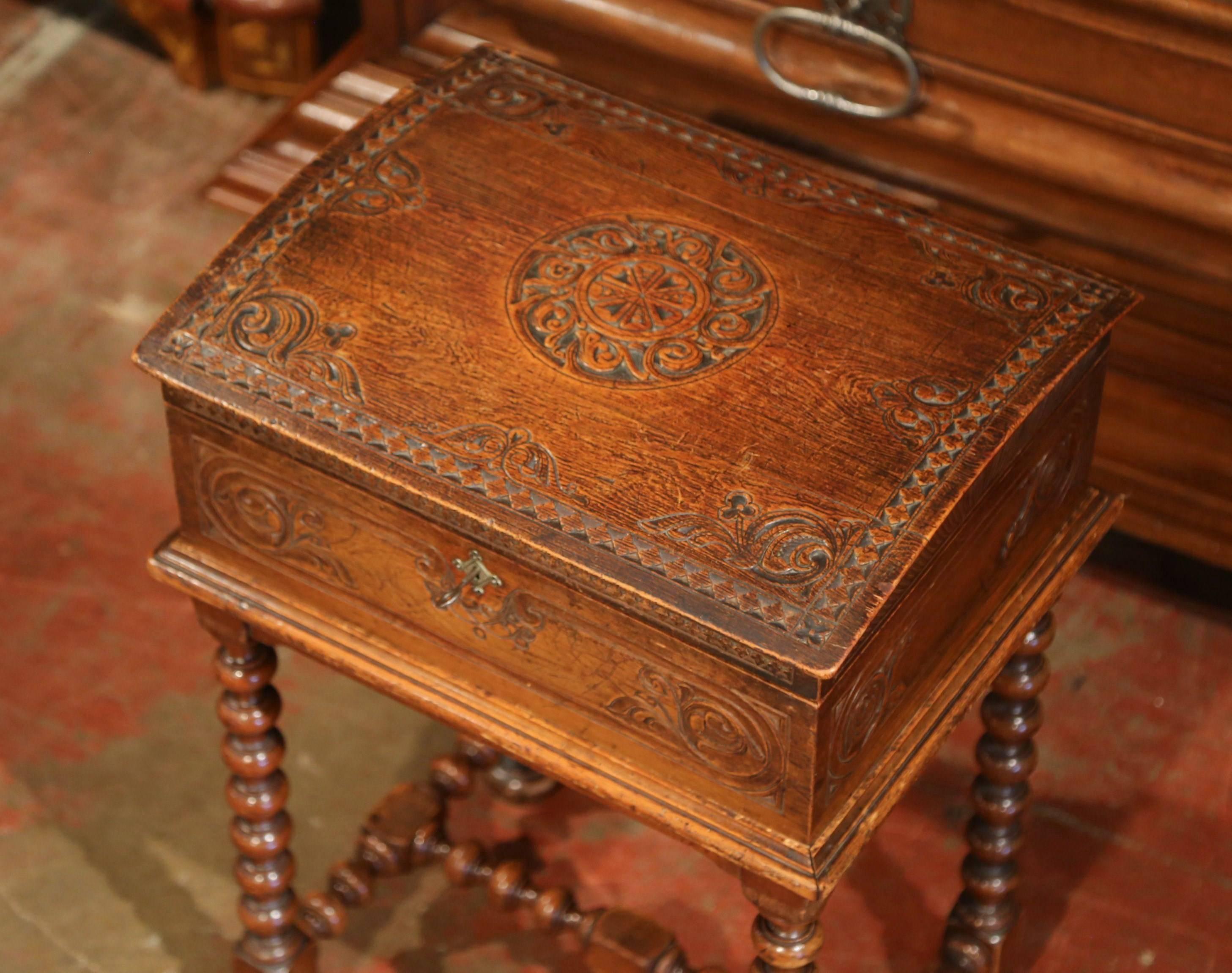 Store your remote controls or small personal belongings in this elegant antique trunk. Crafted in Normandy, circa 1850, the bombe chest sits on a separate base with turned legs and bottom stretcher. The box features hand carved motifs on all four