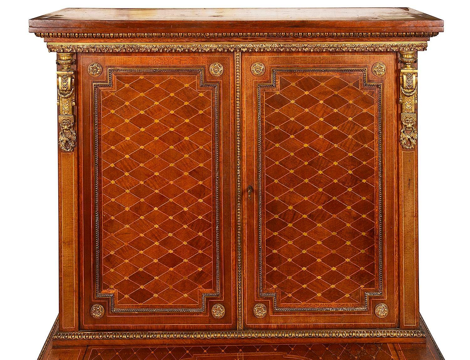 A very good quality late 19th Century French Bon hour du jour. The pair of doors above having wonderful parquetry inlaid diamond shaped inlay, a sliding tablet  opening to write upon. The single frieze drawer having a central classical gilded ormolu