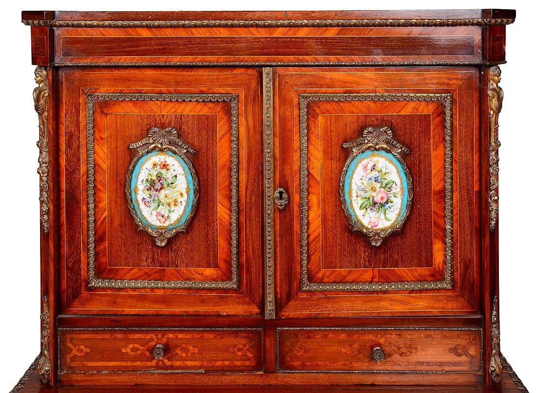 A good quality 19th century French ormolu mounted Bonheur du jour, having Sevres style porcelain plaques inset in to the doors with hand painted floral decoration. Cross-banding to the doors and drawers, gilded ormolu mouldings, two frieze drawers,