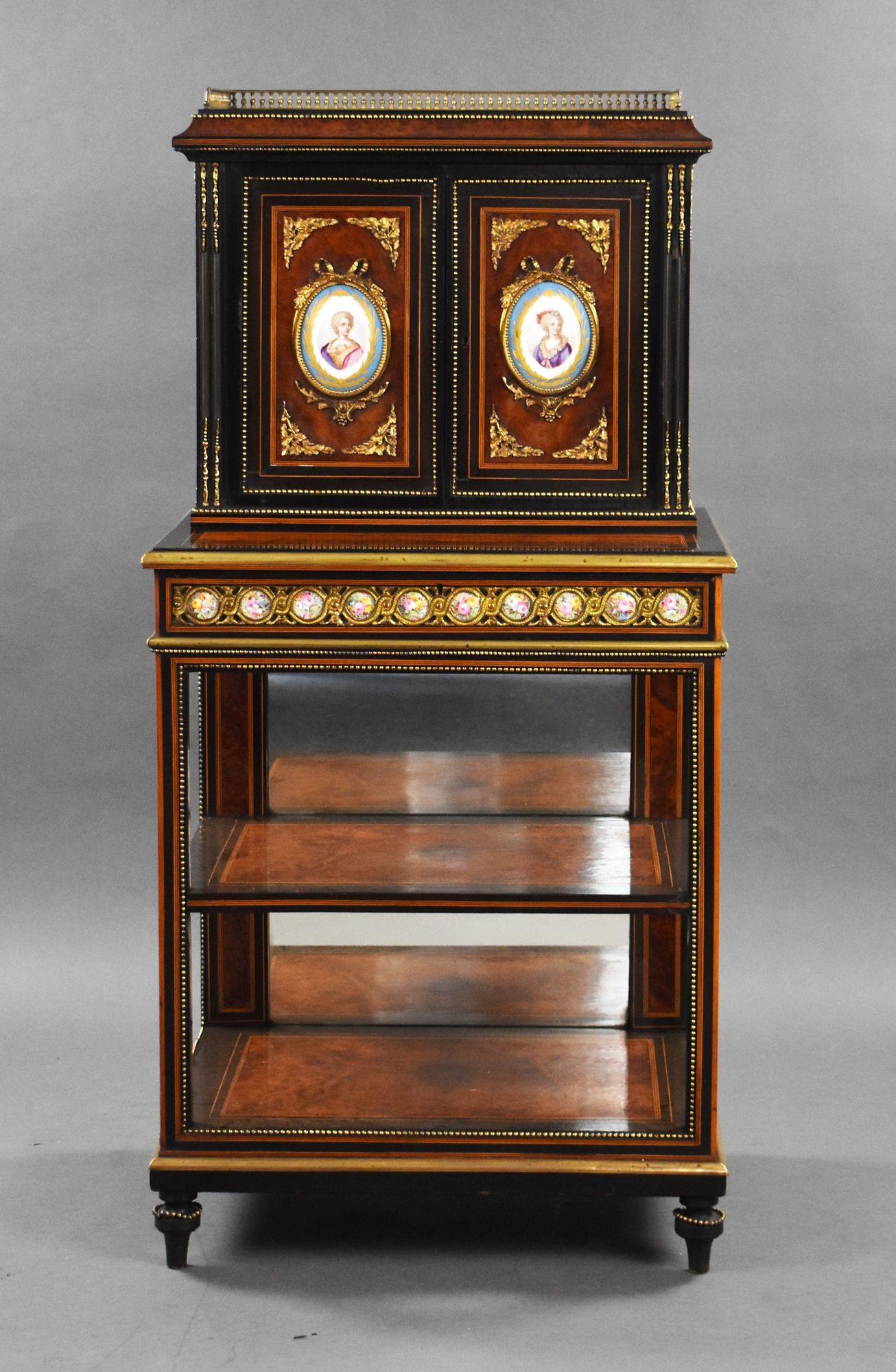 For sale is a French 19th Century Amboyna and Ebony Cabinet, with three quarter balustrade gallery, above two panelled doors set with Paris porcelain portrait panels upon a two tier open stand with gilt metal mounts and a porcelain panelled frieze.