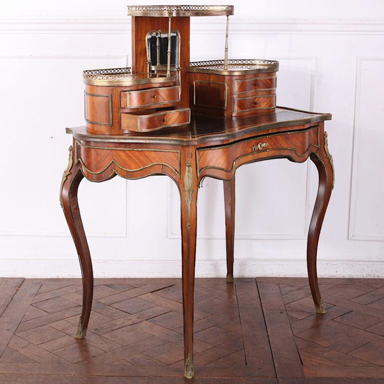 A pretty French Louis XV style writing desk or ‘bonheur du jour’, the serpentine case veneered in book-matched Kingwood and raised on elegant cabriole legs and accented with gilt trim throughout. Single drawer to the frieze and with fitted