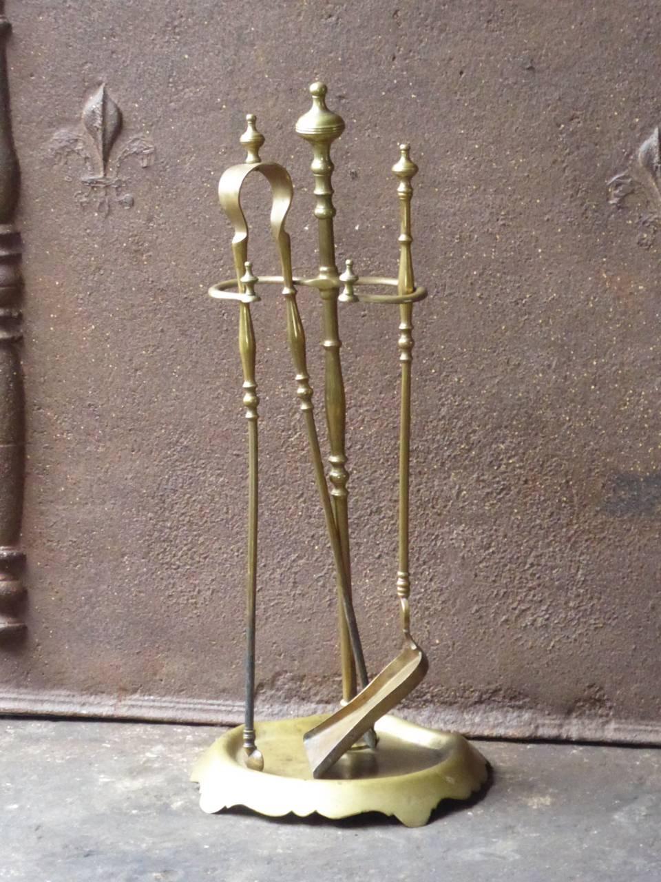 19th century French fireplace tool set made of brass. The fire irons are made by Bouhon Frères which were prominent French producers of fireplace tools in the 19th century. The firm participated in the 1878 and 1900 Paris Expositions Universelles.