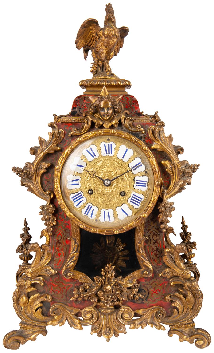 A good quality late 19th century French tortoiseshell and brass inlaid Boulle clock garniture. Having an ormolu cockerel finial above the clock face with enamel numerals, rococo gilded ormolu mounts, a glazed window displaying the sunburst pendulum.