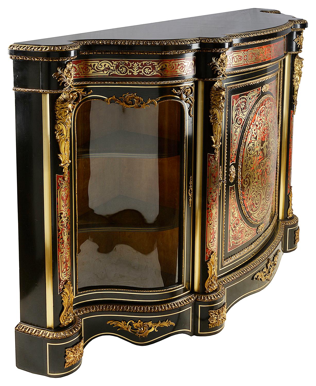 A very good quality 19th century French Boulle serpentine fronted credenza, having shaped glazed doors to either end with shelves within. The central door with classical scrolling foliate decoration to the brass inlay and a classical figure in the