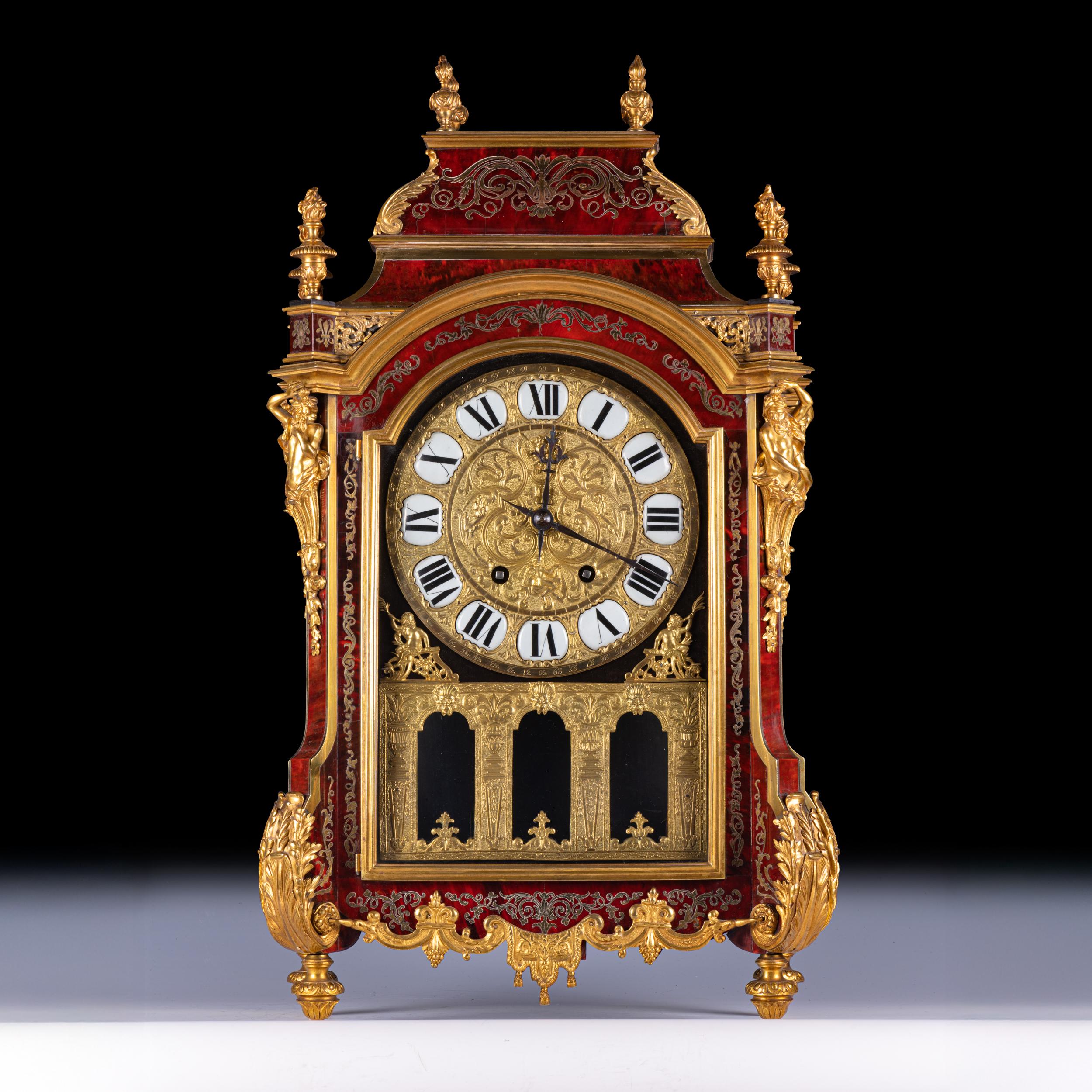 A fine 19th century Louis XIV style ormolu and brass Boulle style mantel clock, in the manner of Martinot of Paris, the eight day movement striking the half hours on a bell, with key, fronted by a cast brass dial decorated in bas relief with a
