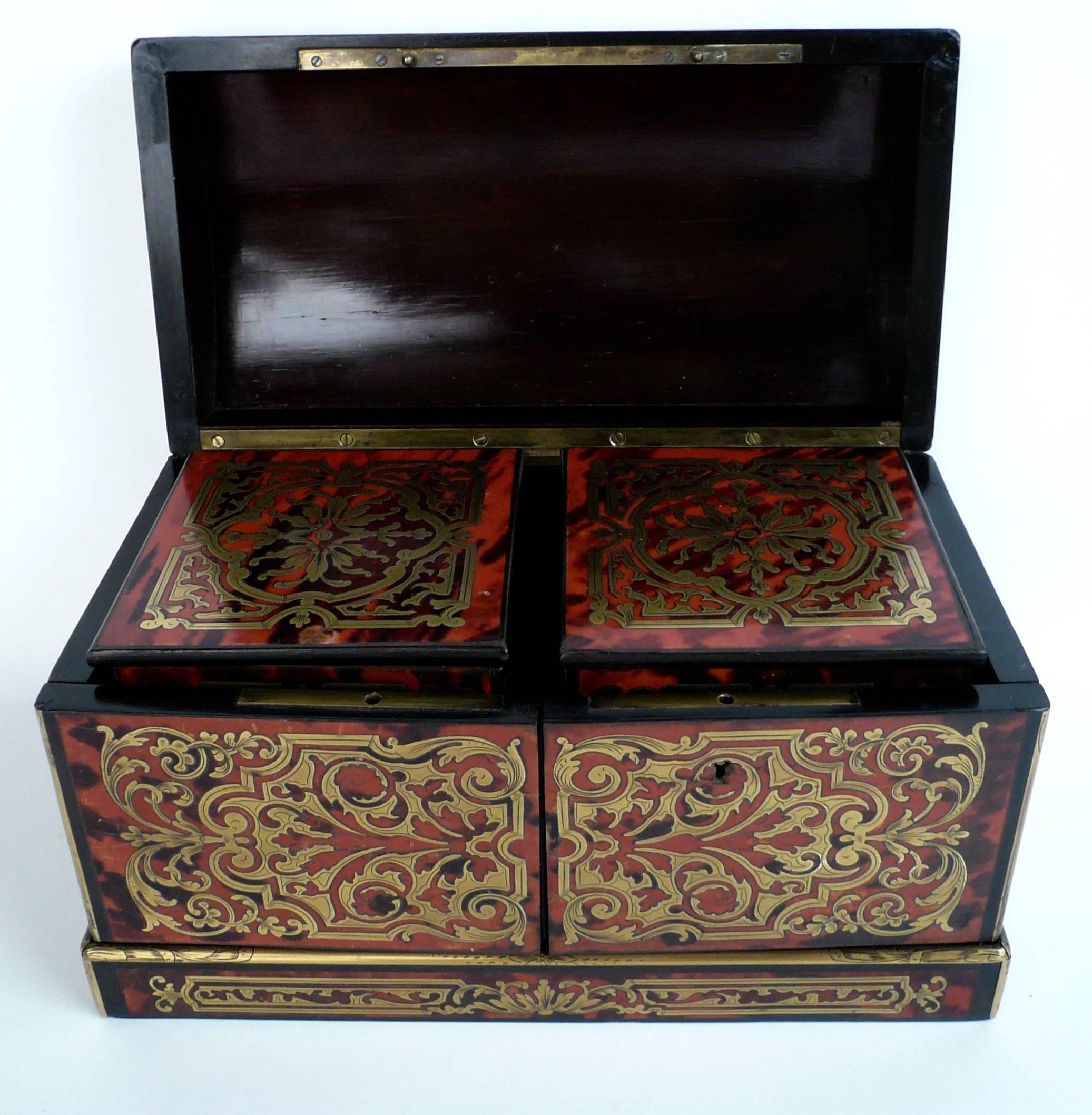 This fine French boulle work tea caddy is beautifully decorated on all sides, with removable interior boxes.