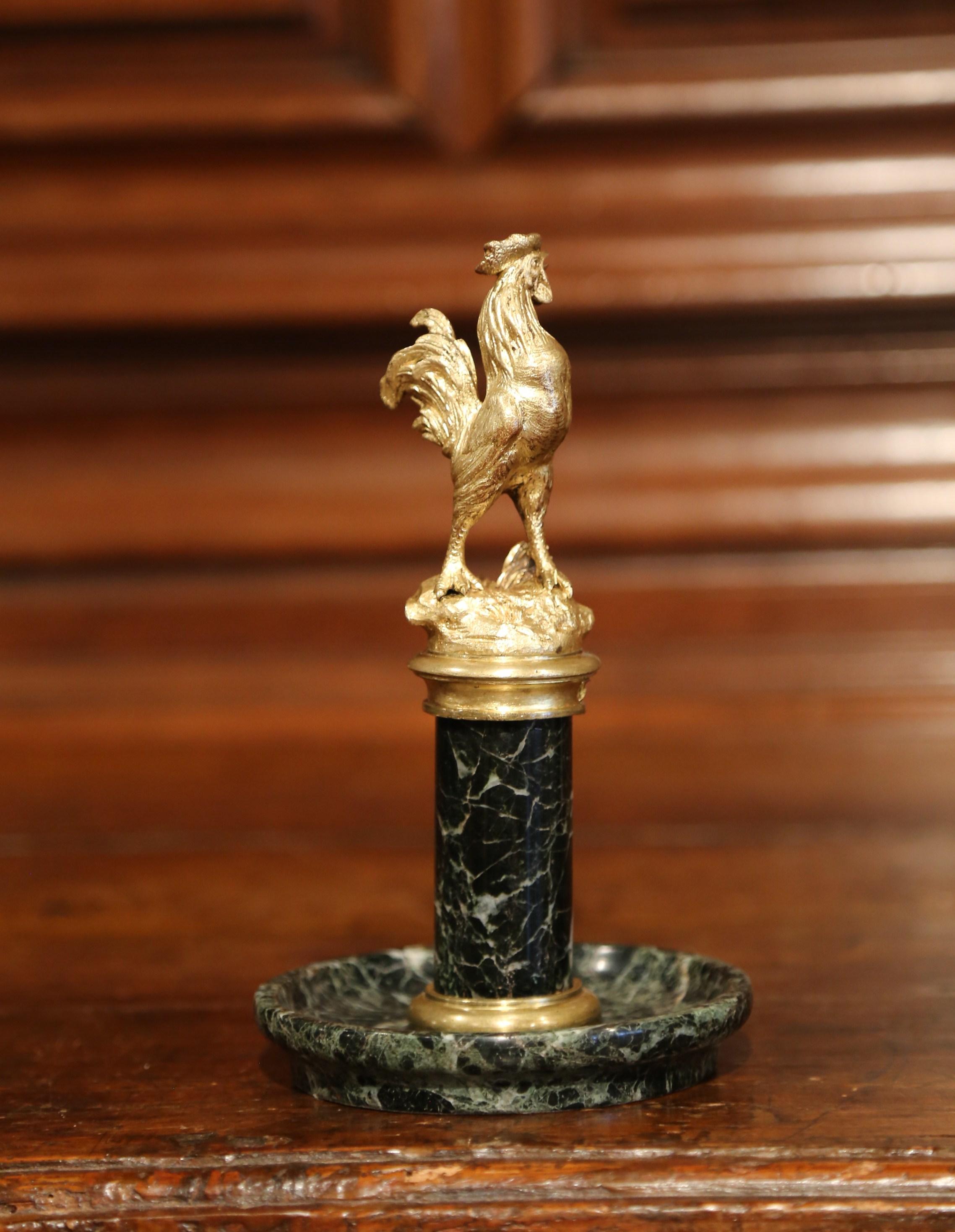 Catch loose change or other odds and ends with this 19th century decorative desktop essential. Crafted in France circa 1890, this ornate vide-poche features a proud bronze rooster standing tall on top of a cylinder pedestal; the circular column is