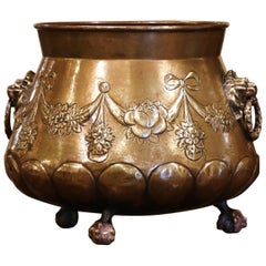 19th Century French Brass Cache-Pot with Lion Head Handles and Repousse Decor