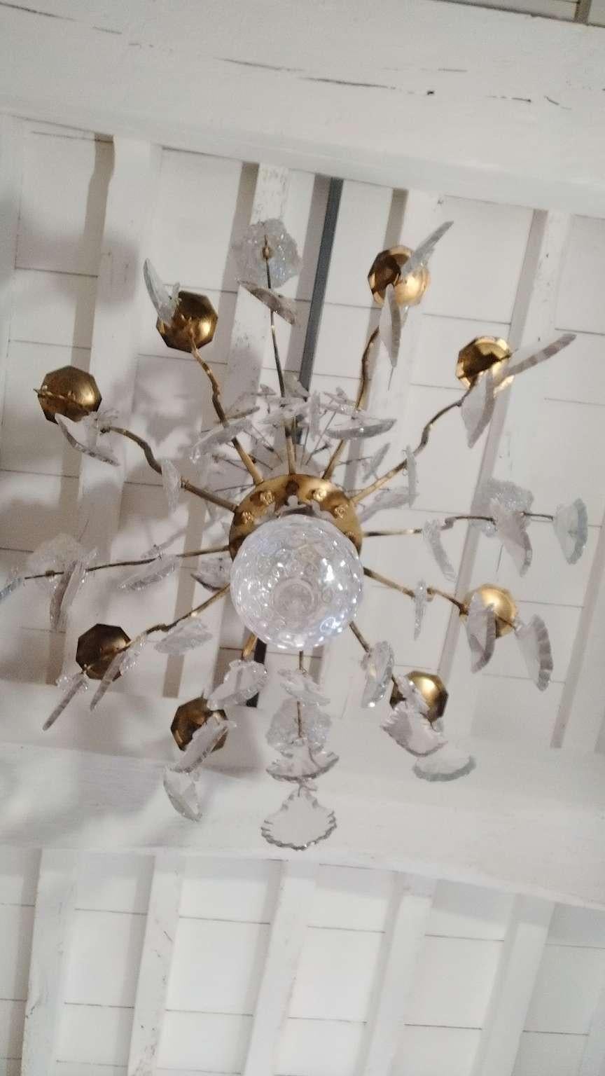 This 19th century crystal and brass chandelier of a large size comes from a church in the south of France. It was made circa 1820. It has height exterior lights, large shaped crystals and four crystal daggers as well as a large cut-glass ball. Note