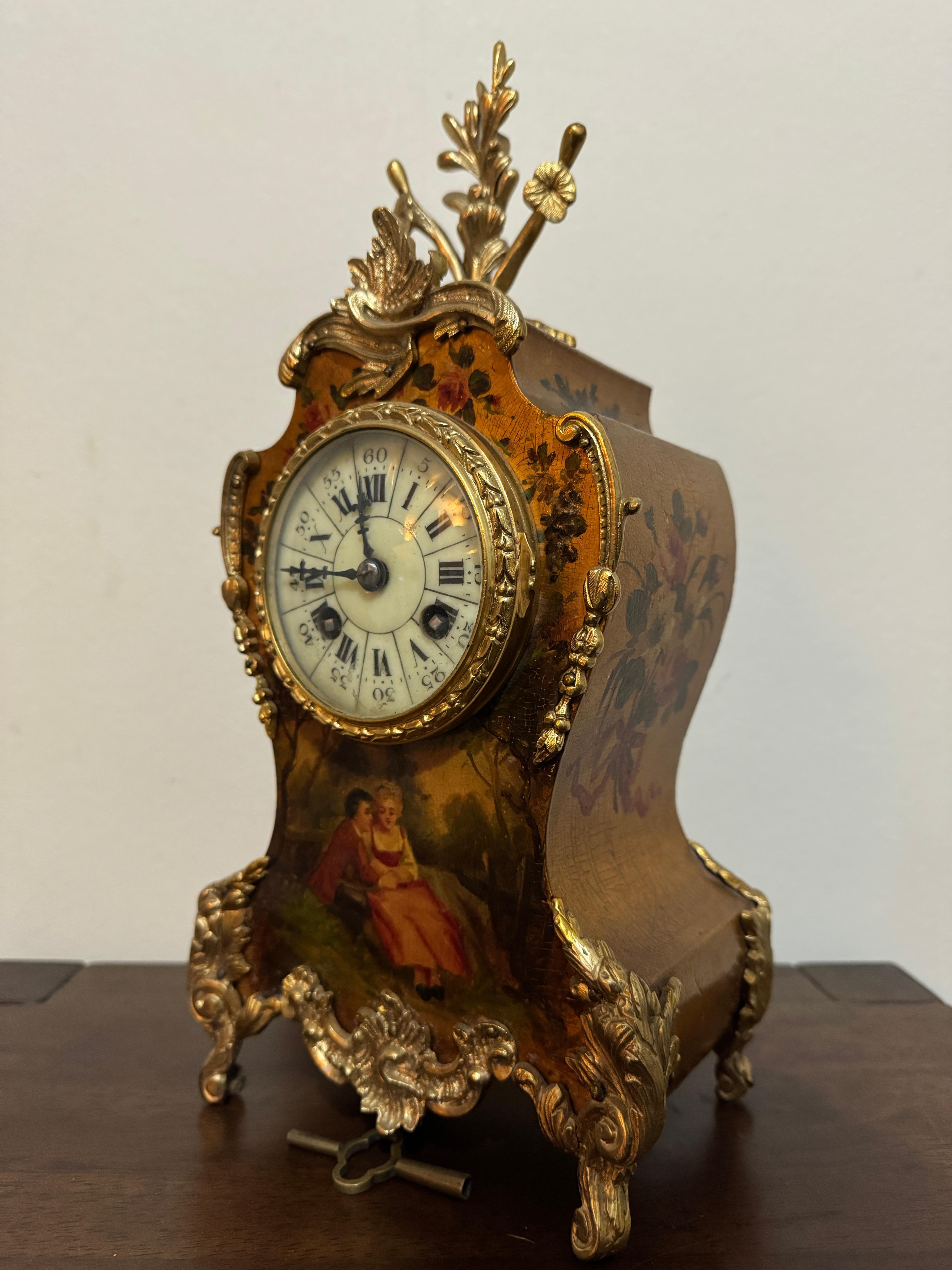  19th Century French brass mounted Louis XV-style mantel clock, by Japy Freres.
Decorated in the Vernis Martin style with Watteauesque-style scene of a young courtship couple beneath an ivory colour dial with Roman and Arabic numerals, the sides