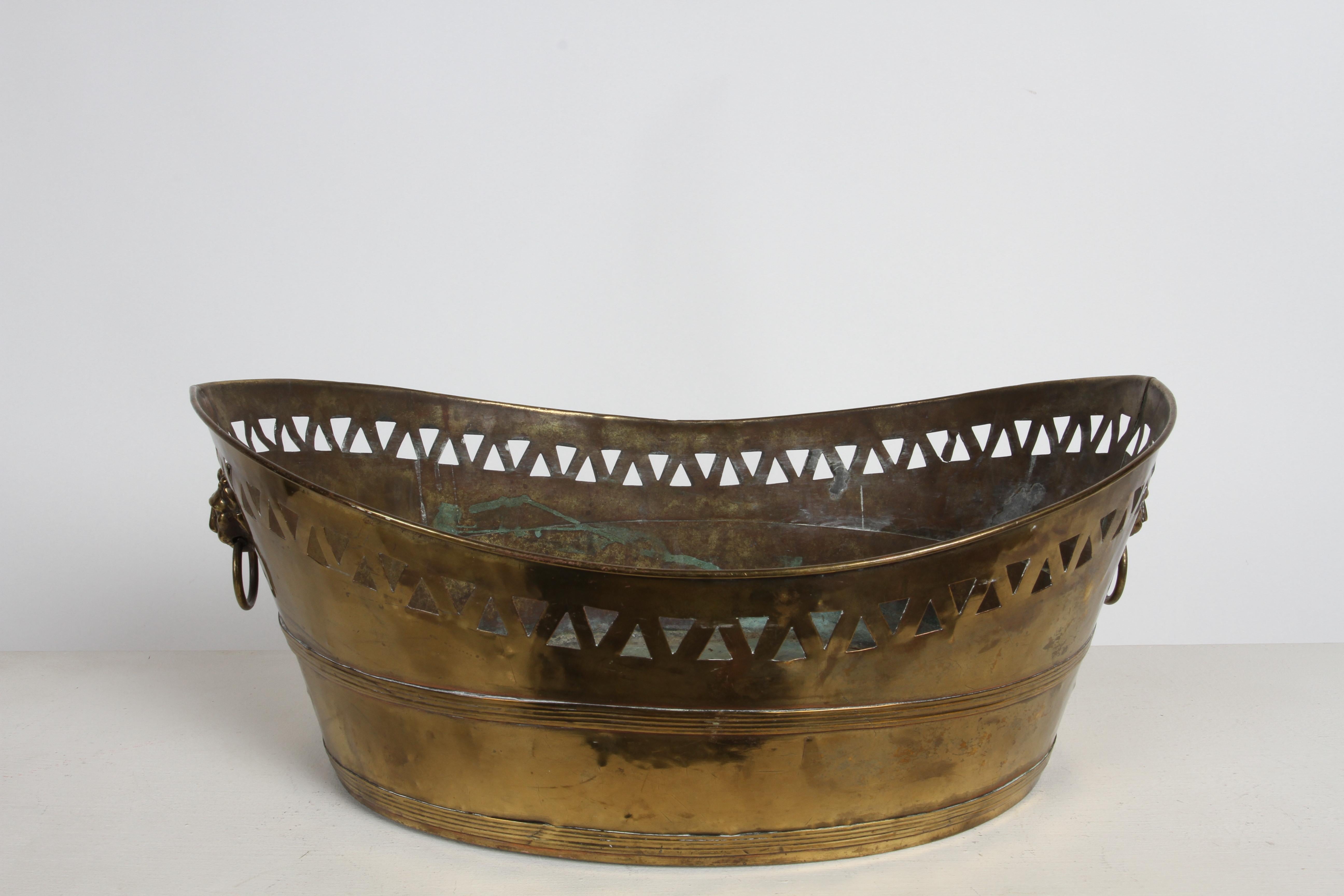 French 19th Century brass boat - shaped Jardinière with pierced gallery rail around the top and cast bronze lion head handles with ring pulls. Perfect for displaying flowers,  fruits or potted plants. Missing original liner.

From the estate of