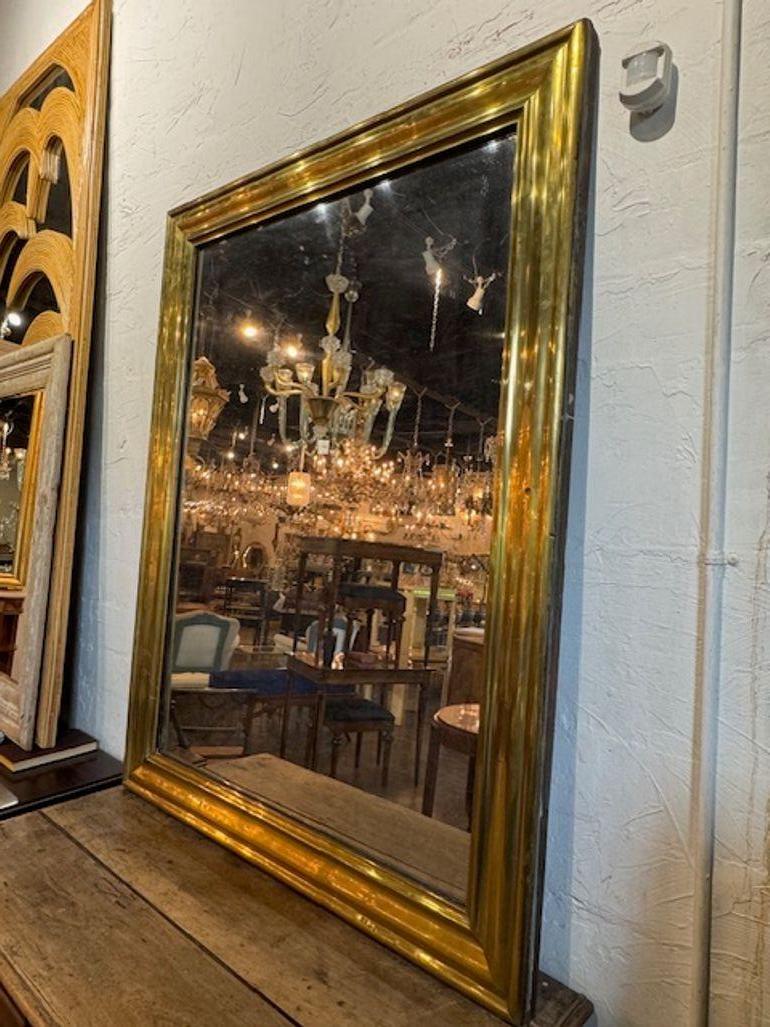 El espejo de estilo transicional de latón francés del siglo XIX es un complemento elegante y con estilo para la decoración de cualquier hogar. Este espejo desprende un encanto intemporal con su diseño transicional y  acentos de latón, que recuerdan