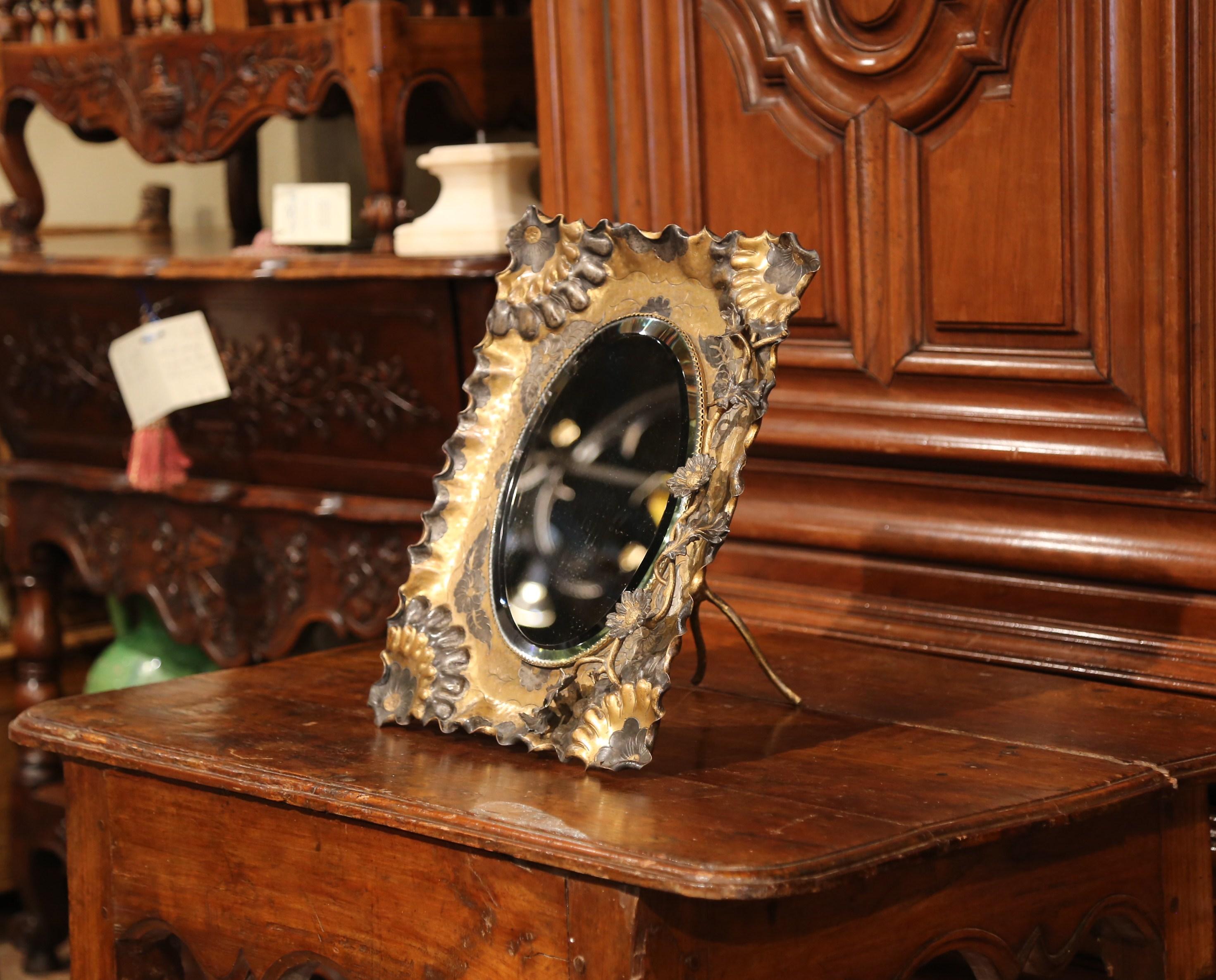 Decorate your master bath or guest room with this elegant and colorful free standing antique mirror; crafted in southern France, circa 1890, the rectangular brass mirror features a centre oval mirror with bevelled and mercury glass, and is