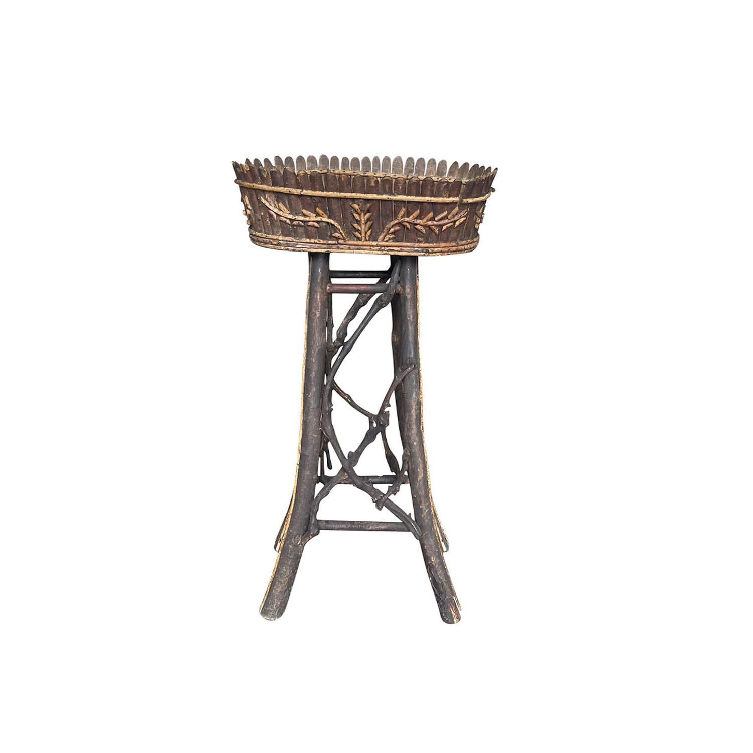 An antique 19th Century, French Brienzer style jardiniere planter made of hand crafted wood, in good condition. The Art Populaire planter, oval flower basin is meticulously hand-decorated with small wooden slats and a floral design. Weathered
