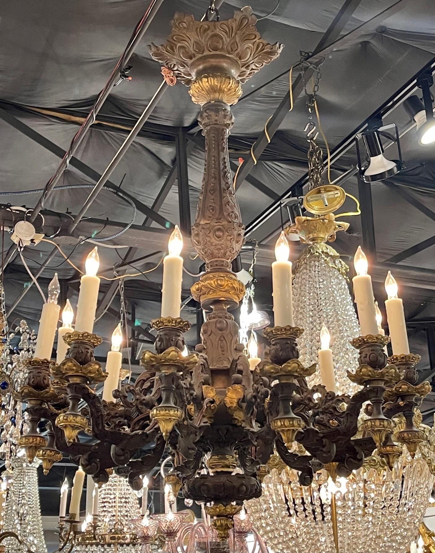 Handsome 19th century French bronze 12 light chandelier in gold and black. Nice decorative details and very fine quality! Super elegant!