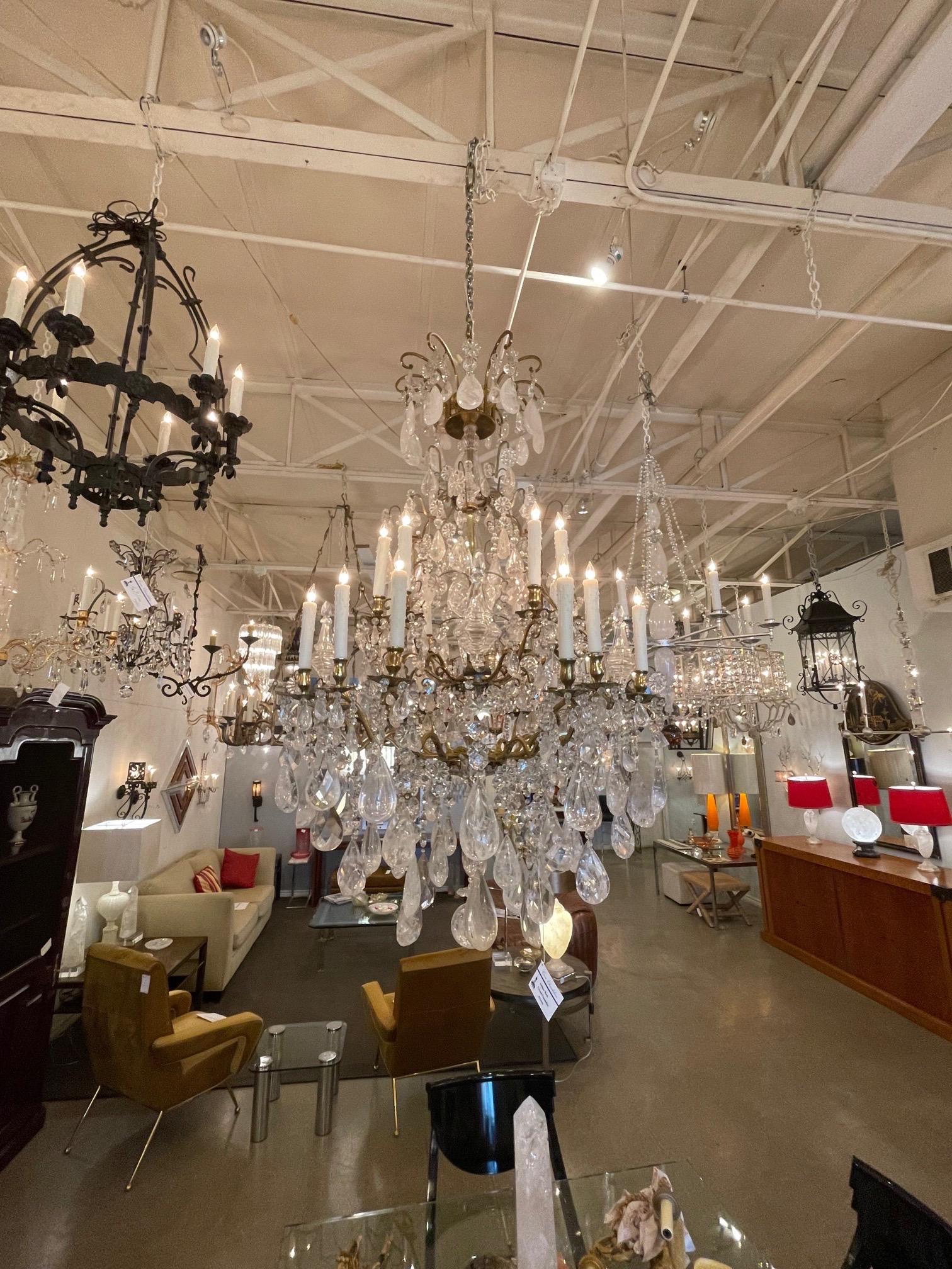 Large scale 19th century French bronze and rock crystal chandelier. Featuring a plethora of various sizes of beautiful rock crystal, some enormous. Very impressive!!