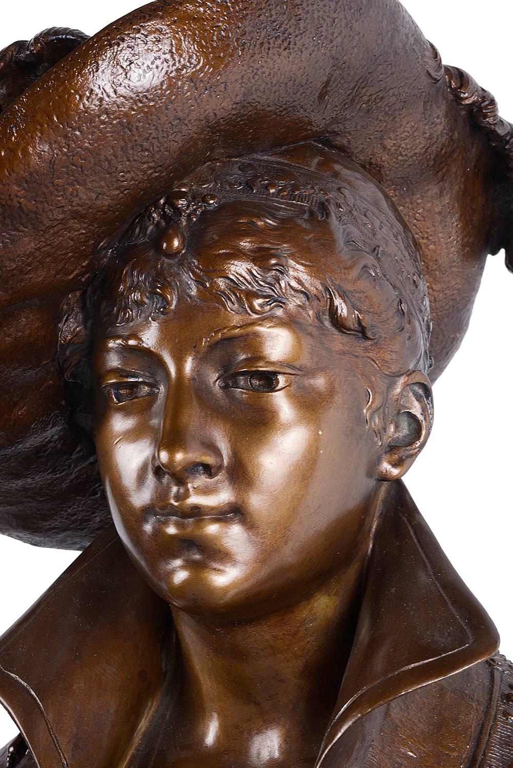 A very good quality late 19th century bronze bust of a classical lady wearing a hat.
Label to reverse; Eug. Bagues.