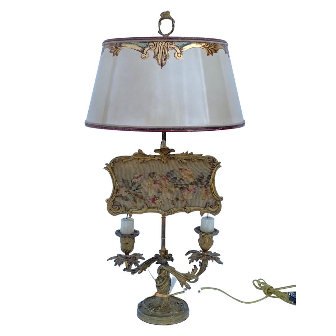 Originally a two-armed candlestick. Original, adjustable screen with aubusson insert. Converted to lamp with custom, hand-painted parchment shade.