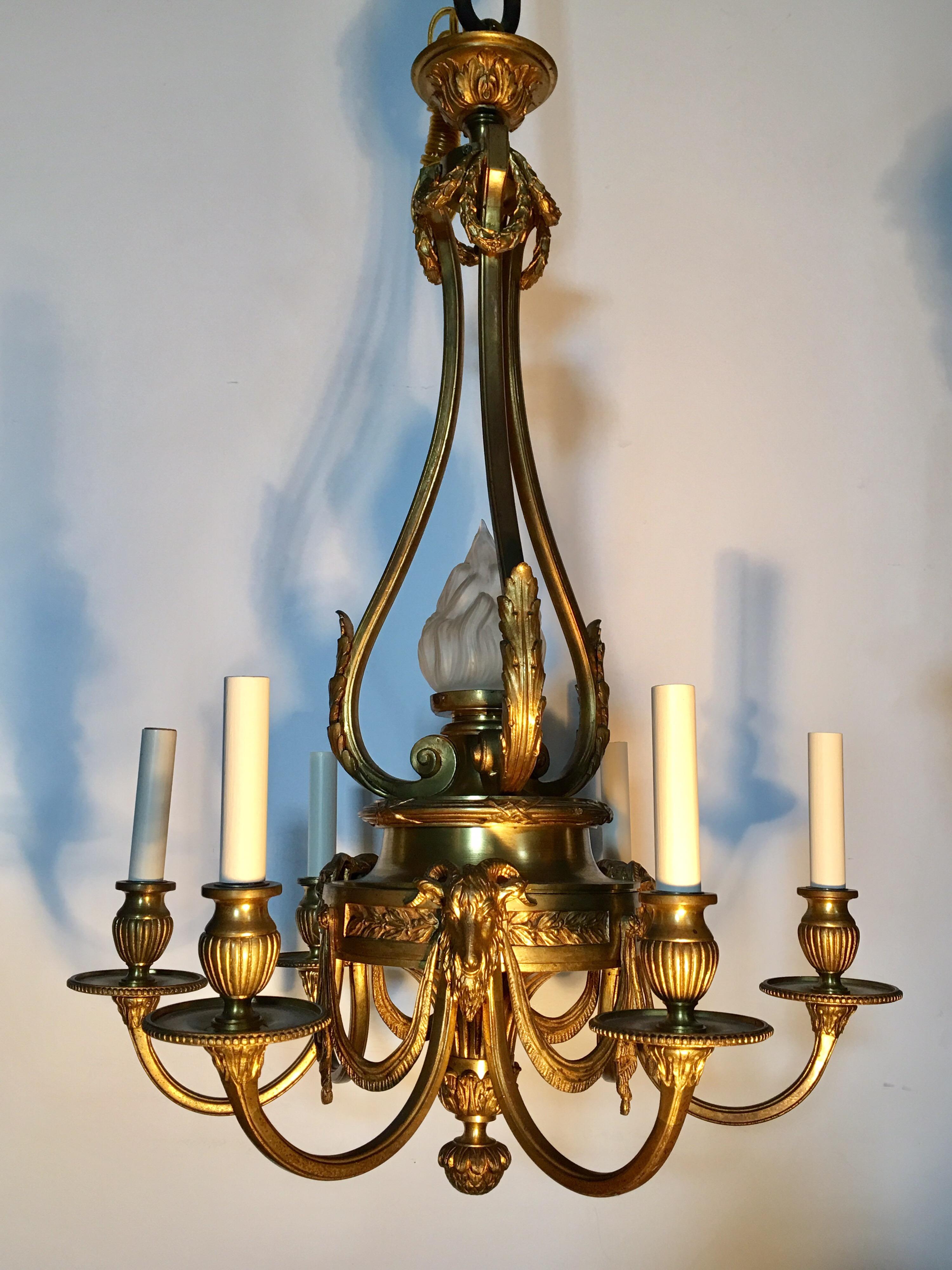 A very fine 19th century French Louis XVI style bronze chandelier with six lights. The chandelier is adorned with beautiful acanthus leaf pattern, goat head motifs, swags, a lovely finial along with other decorative details. The center features a