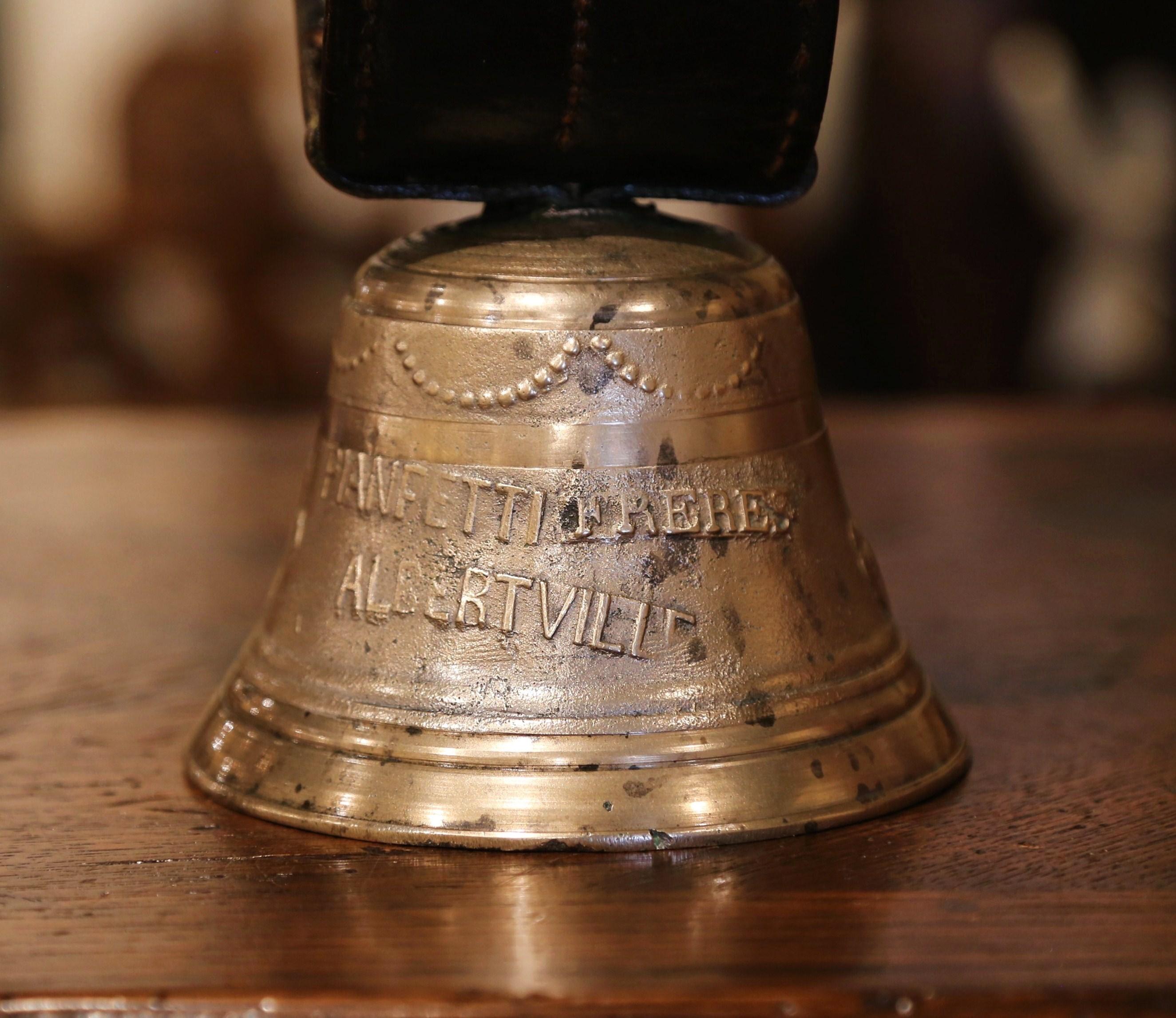 Bring the French countryside into your home with this patinated bronze bell from Albertville in the Alps region of France; crafted in France circa 1890 and signed Pianetti Freres, the antique bell features several decorations in relief, including