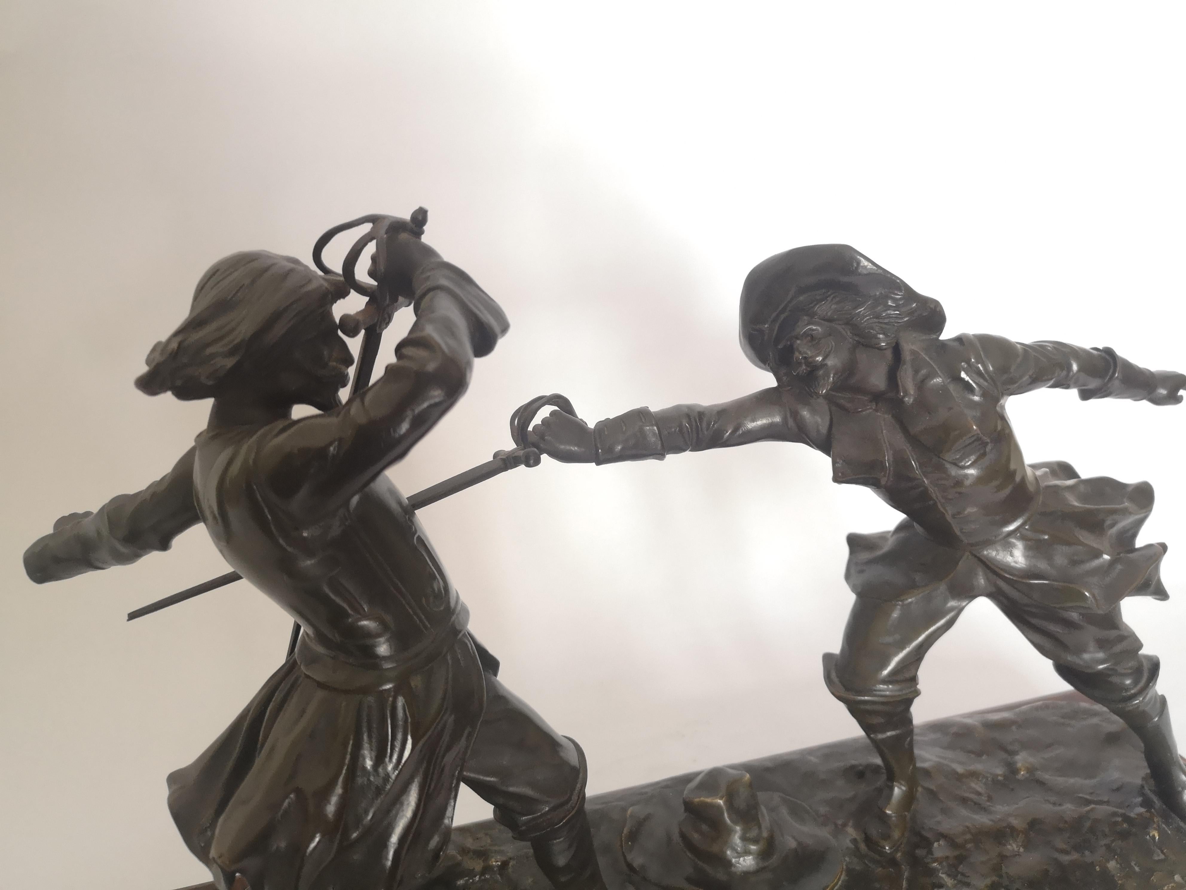 This 19th century French bronze sculpture, naturalistically modelled in bronze showing two men in a fencing duel, raised on a griotte marble rectangular base, the bronze signed 'E. Drouot'.
French, circa 1890.
 