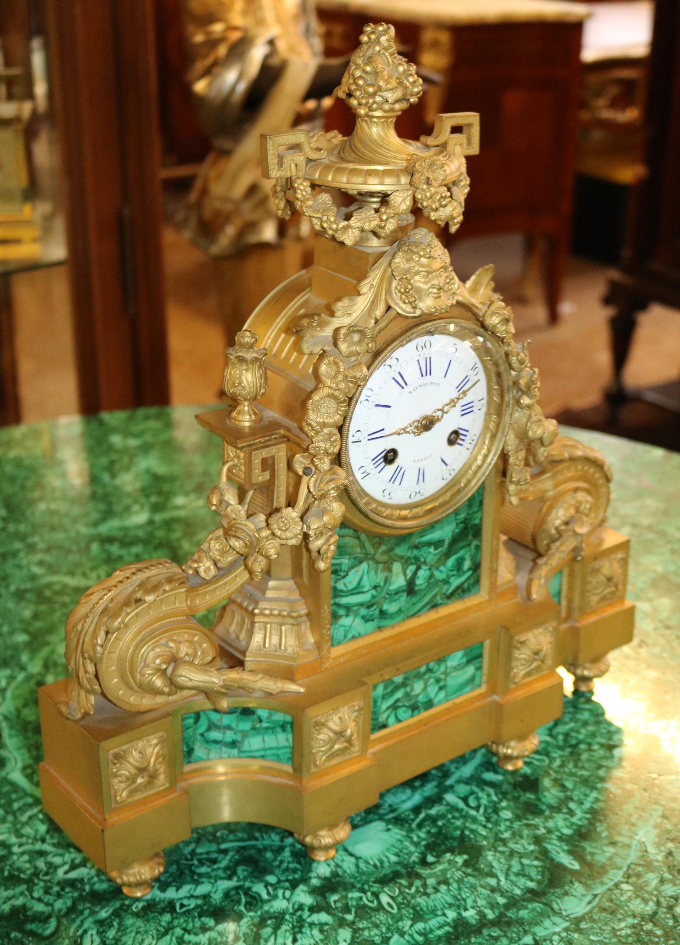 This stunning clock was made in Paris in the 19th century by Raingo Freres one of the top clock makers of the time! The clock is fine cast bronze with malachite inlaid throughout the bronze is crisp and thick. The movement is very high quality!
