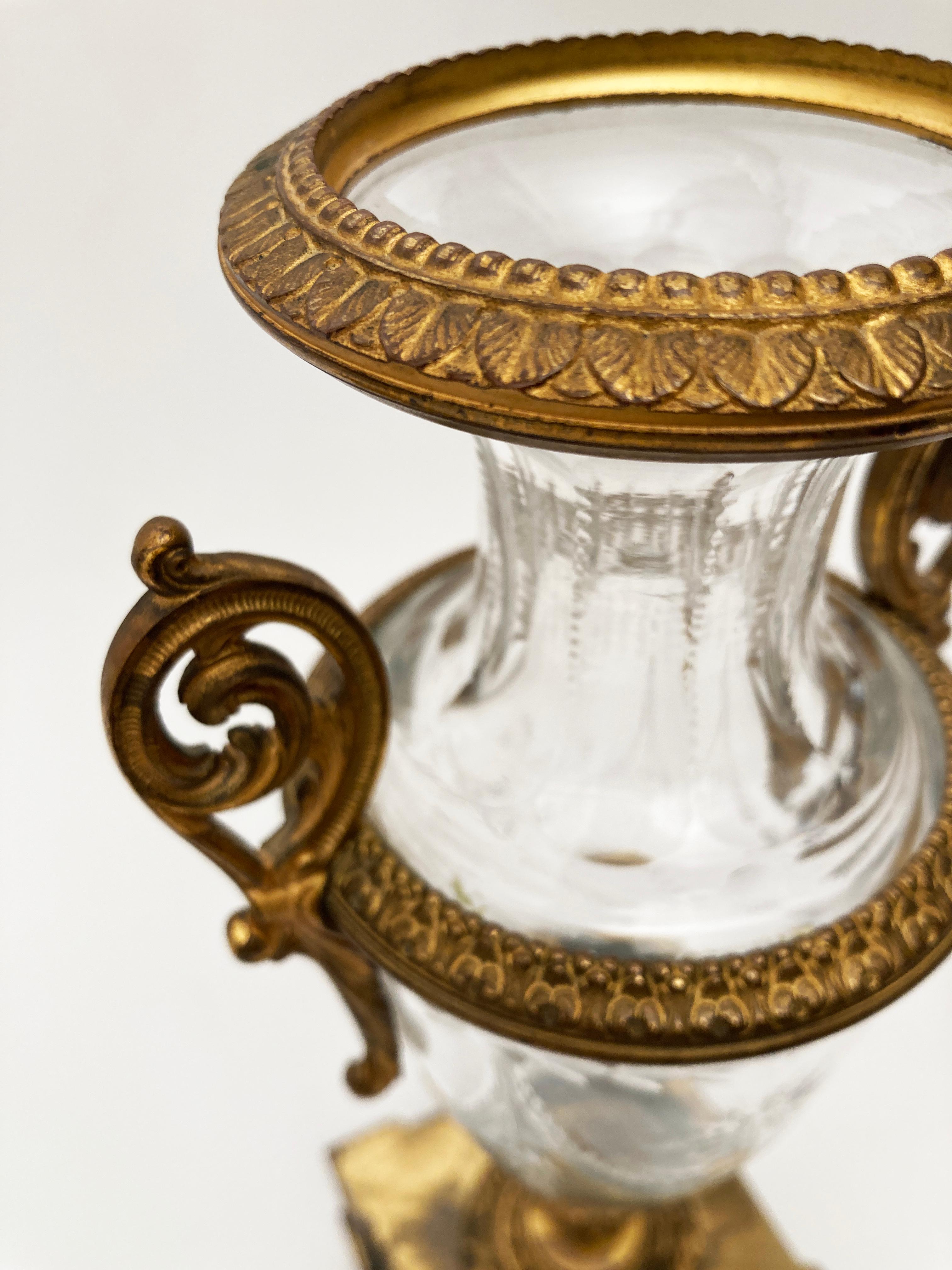 The 19th Century French artisans knew how to design lasting classical beauty. This extraordinary pair of French urns is proof of the mastery put forth in design and construction. From the crystal cut urn with center floral medallion and draped