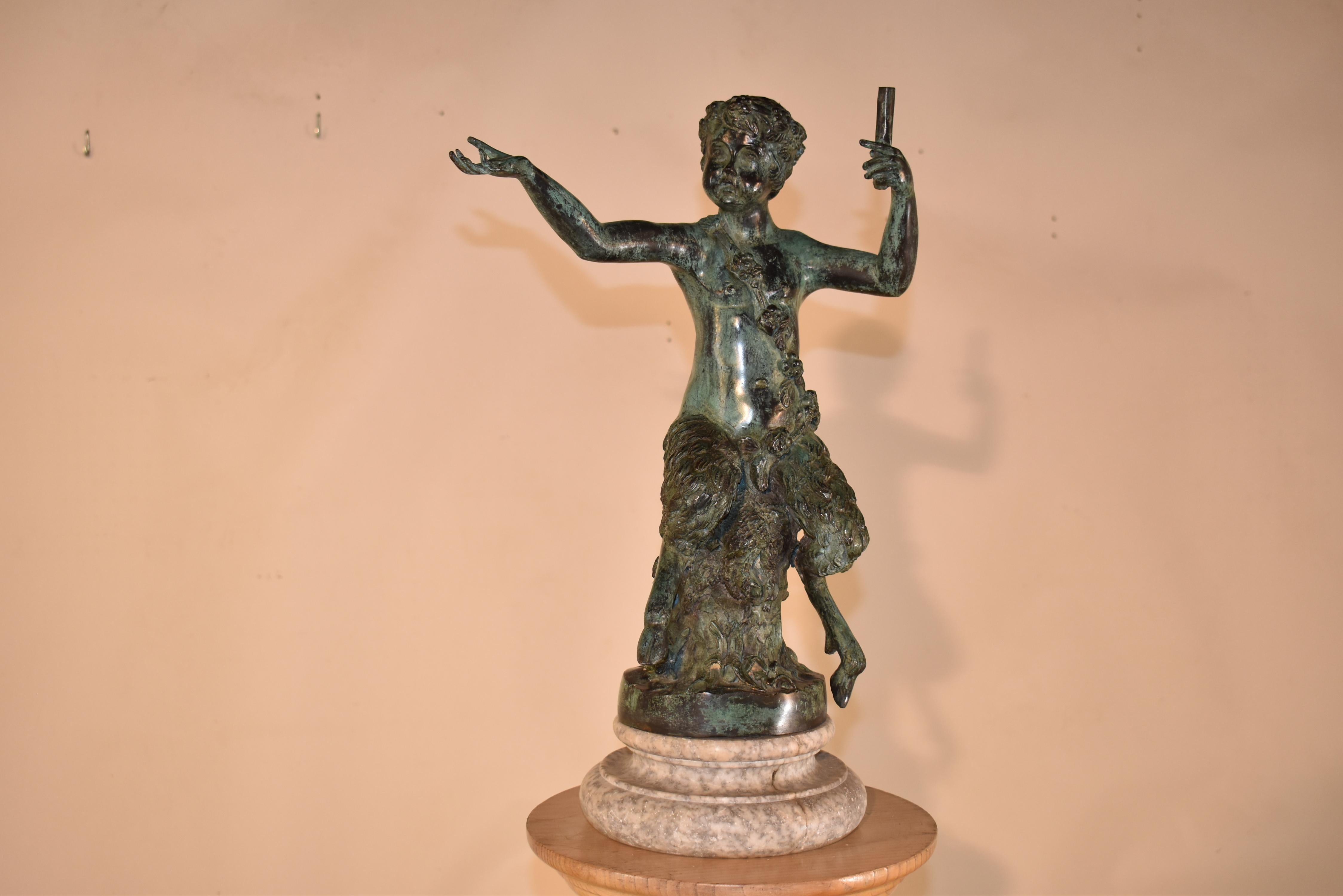 19th century bronze statue of a Pan figure holding a flute from France.

The bronze is expertly cast and features a Pan figure of half of a young boy from the waist up and half of a goat from the waist down.  Pan figures are mythical creatures that