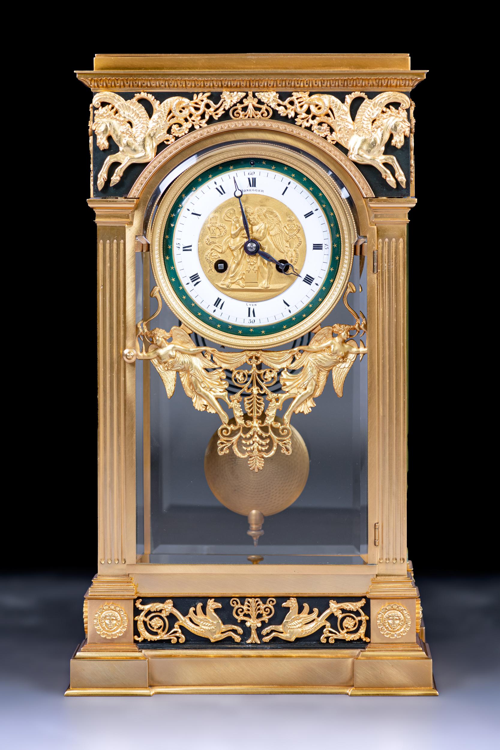 A French four beveled glass mantel clock in the Neoclassical style, the moulded stepped base above a centred ormolu pierced mount to the front of horses.
The clock features a circular white enamel dial, which is inscribed with Roman Numerals
