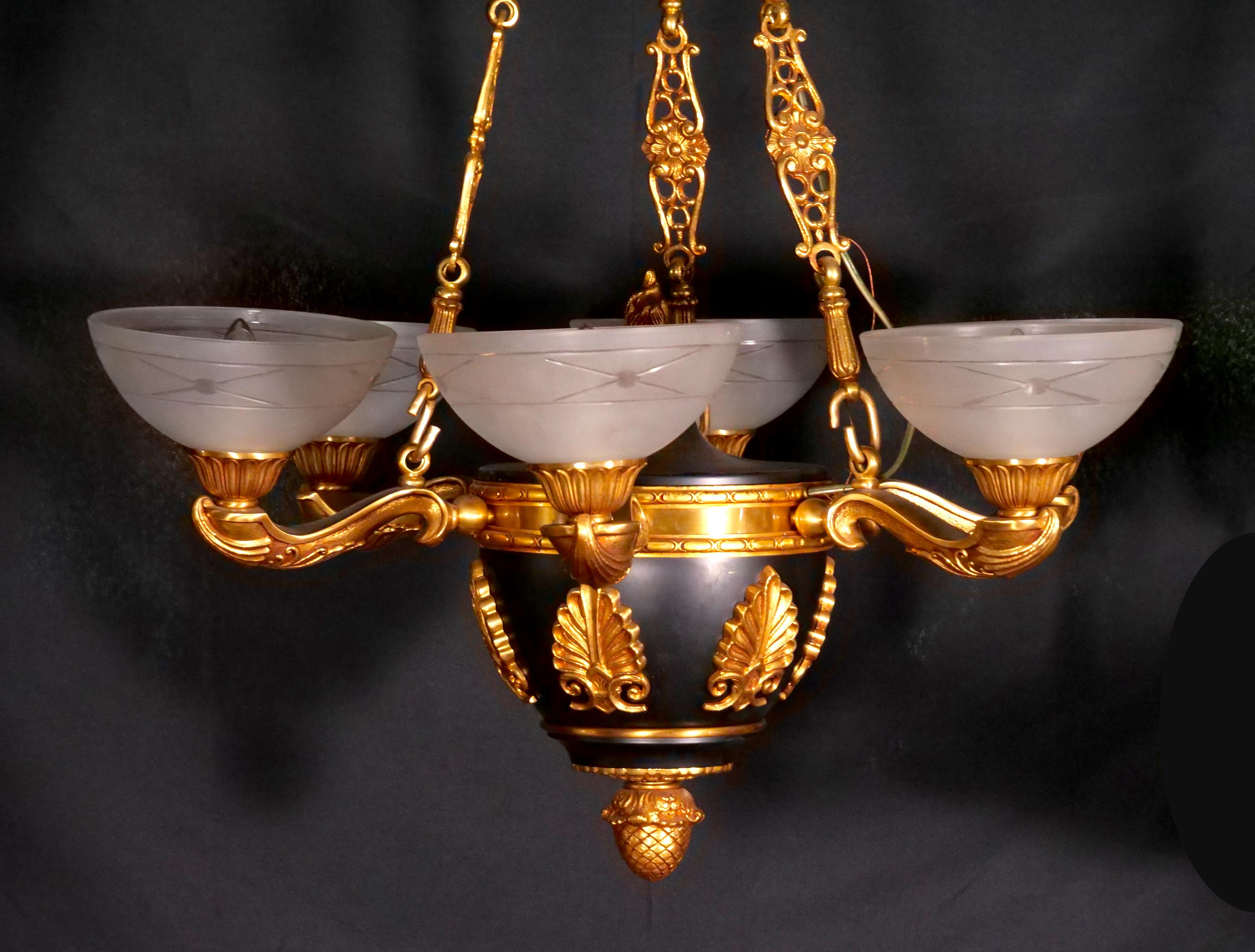 Illuminate your space with timeless elegance using this exquisite 19th Century French Empire Style Bronze Chandelier, designed in the form of a Greek oil lamp. This chandelier is a remarkable fusion of art and functionality, meticulously crafted