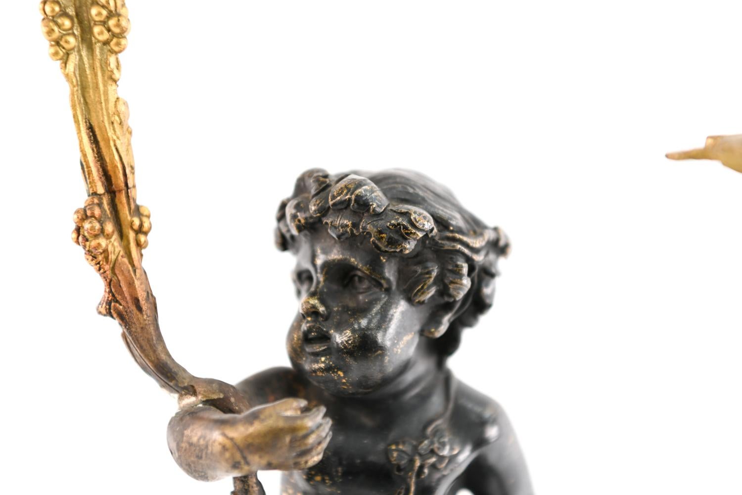 A stunning 19th century French bronze candelabra in the form of a satyr.