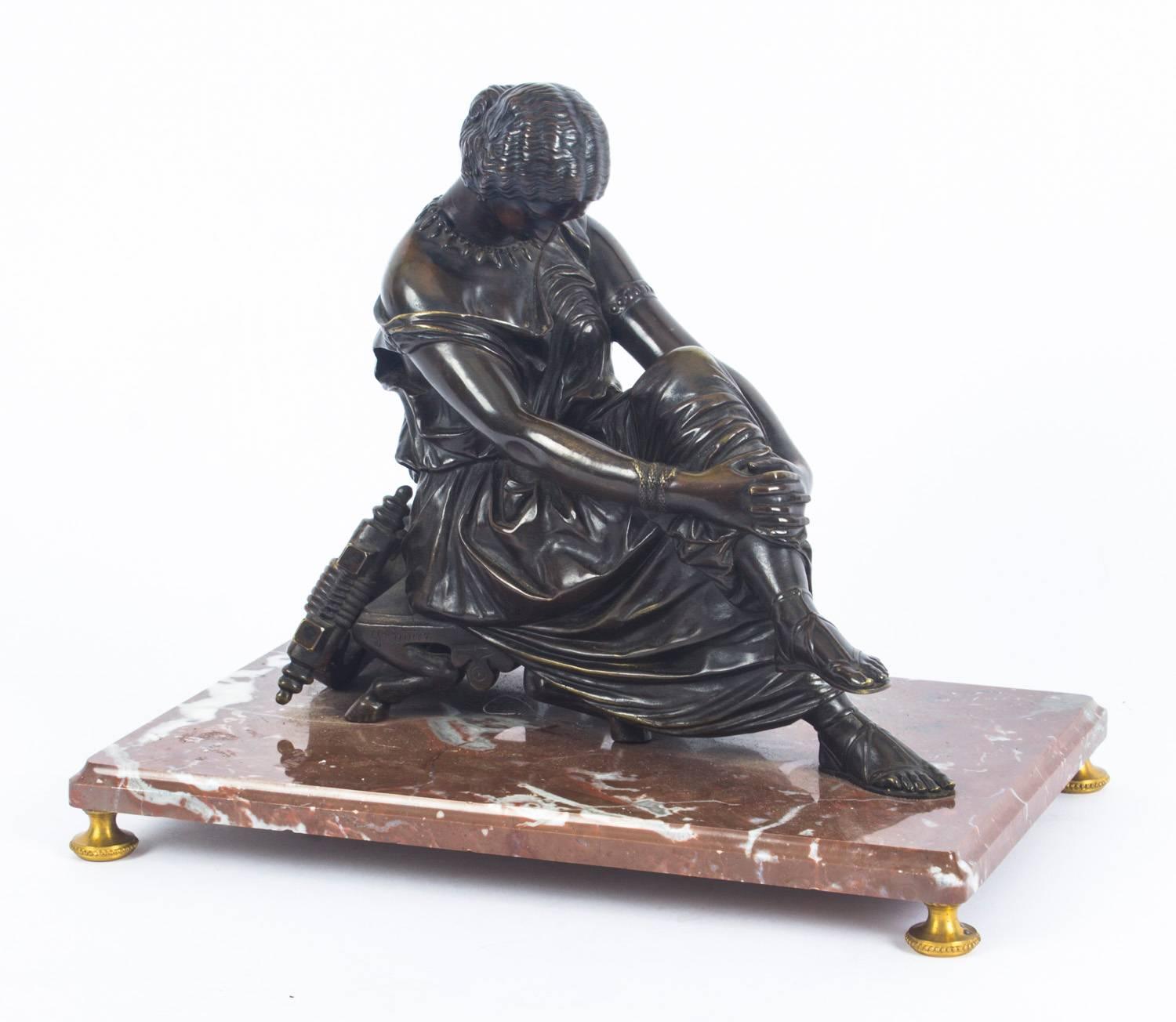 A beautiful French patinated bronze sculpture of a study of the seated poet Sappho, signed J. Pradier, with Suisse Freres foundry mark, circa 1830 in date.

The sculpture portrays the classically dressed poet Sappho seated on a stool with a lyre,