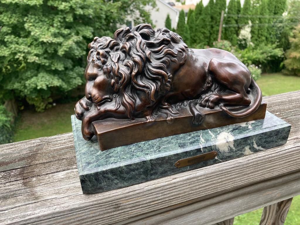 A fine sculpture depicting a lion asleep with paws crossed. Beautifully cast with a rich caramel patina. Perfect for a desk top, bookshelf or mantel piece. Mounted on a green and white marble base
 
Jules Moigniez (1835–1894) was a French