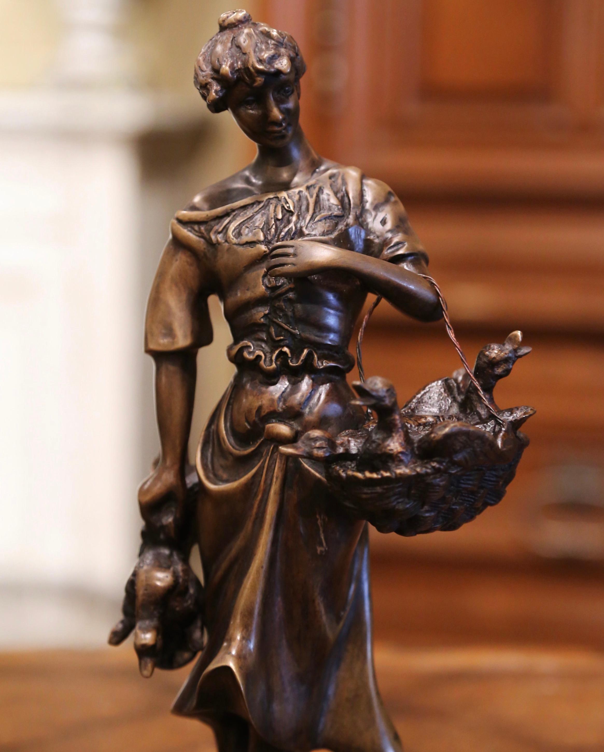This antique sculpture composition is a beautiful example of the works of one France favorite sculptors, Hippolyte Moreau. Crafted in France, circa 1880, the sculpture features a young beauty carrying a basket full of ducks in one hand and a desd