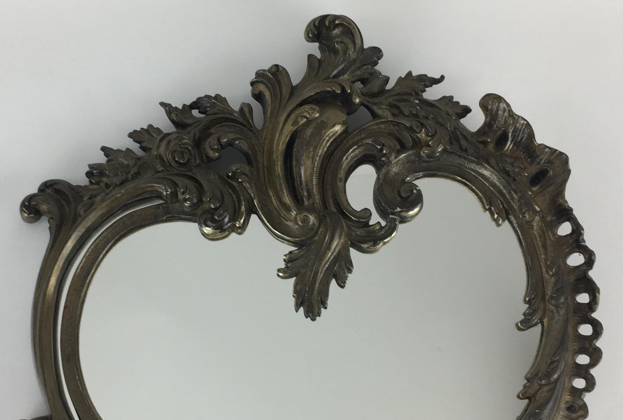 Napoleon III style violin shaped table mirror made of bronze with a silvered rocaille decor of scrolled acanthus leaves, small flowers and on the bottom left a Mythological animal called 
