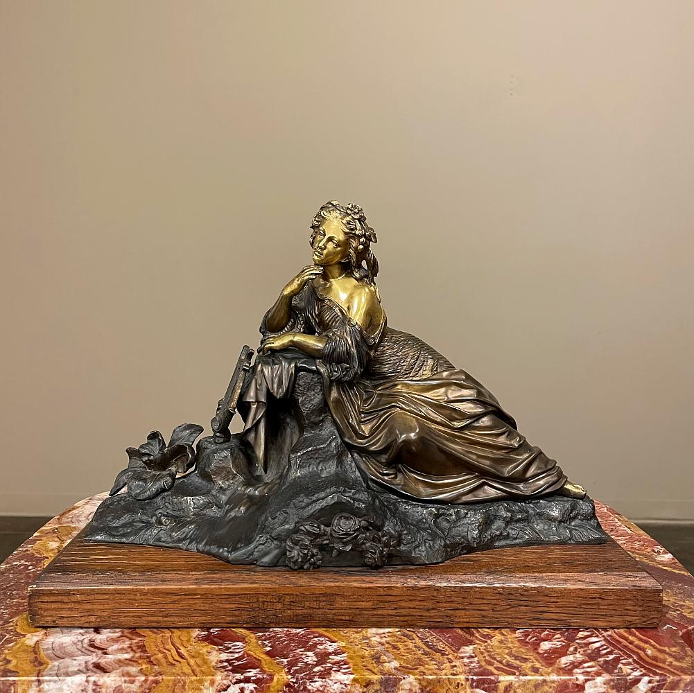 19th century French bronze statue of Maiden with Lyre depicts a beautiful woman in a classical pose, reflecting on the day's events, or life in general, with a faraway gaze in her eyes. Alongside is her lyre, ready when inspiration calls. Note the