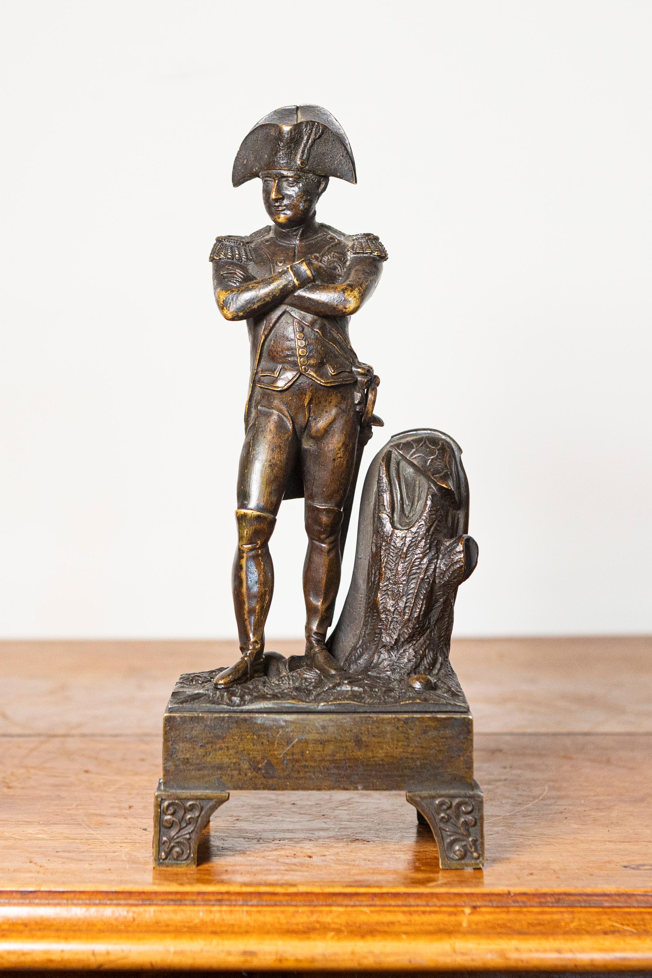 Questa statuetta in bronzo francese del XIX secolo, finemente dettagliata, cattura l'iconica figura di Napoleone Bonaparte in una posa classica e autorevole. La scultura raffigura Napoleone in piedi con le braccia incrociate sul petto e il suo