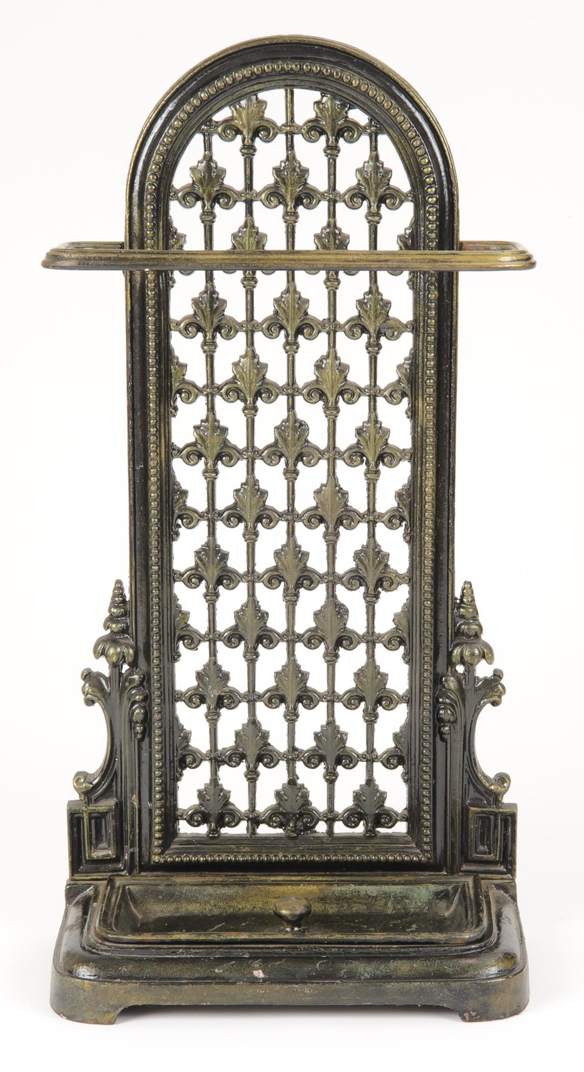 
Napoleon III cast iron in bronze finish umbrella stand with drip tray.  Bead and fancy grill work.  