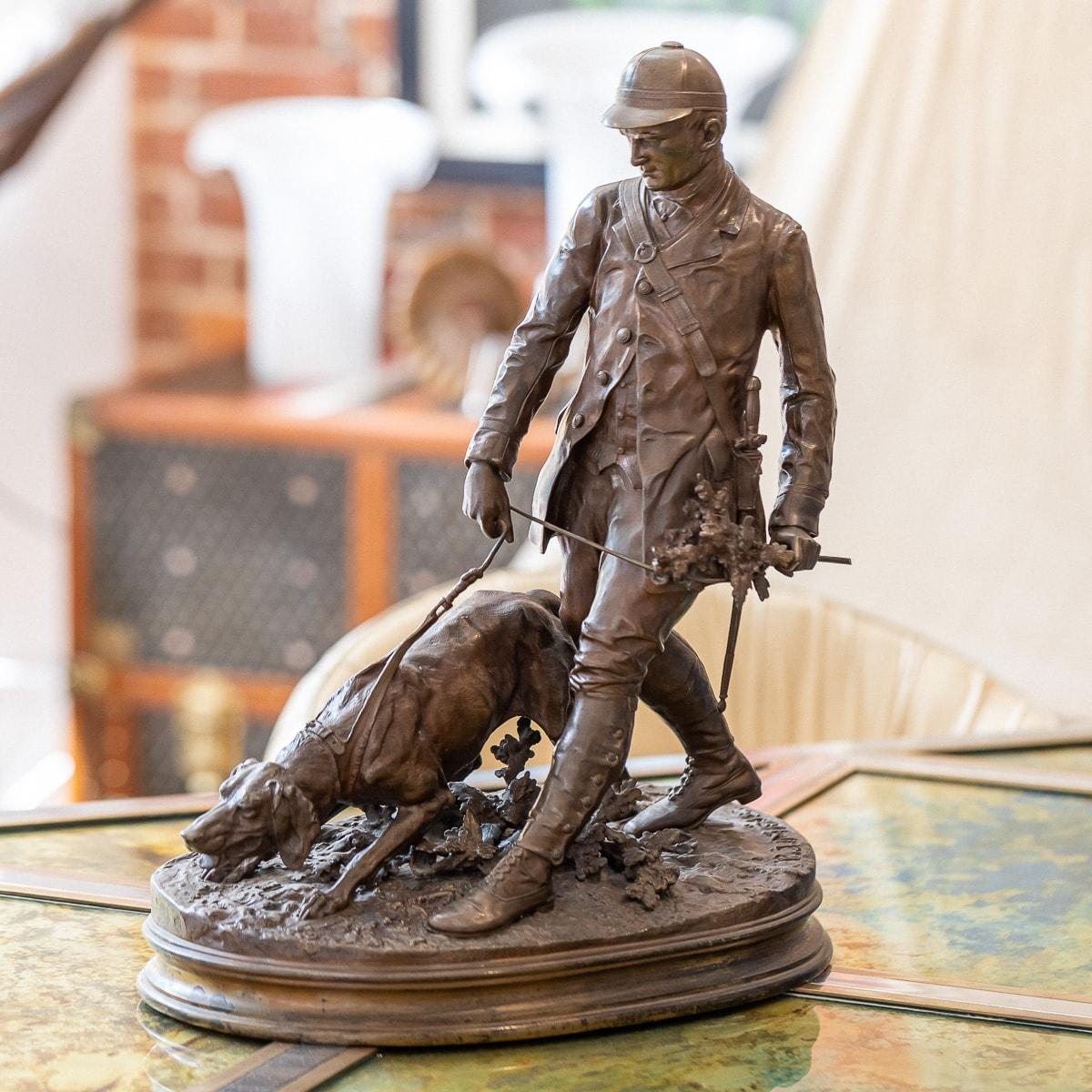 Antique 19th Century French patinated bronze by Pierre Jules Méne (French, 1810-1871), of 'Valet de Limier (The Bloodhound Handler)', the huntsman led by his dog on oval naturalistic base, signed and dated P.J. MÊNE 1879, the proper right side of
