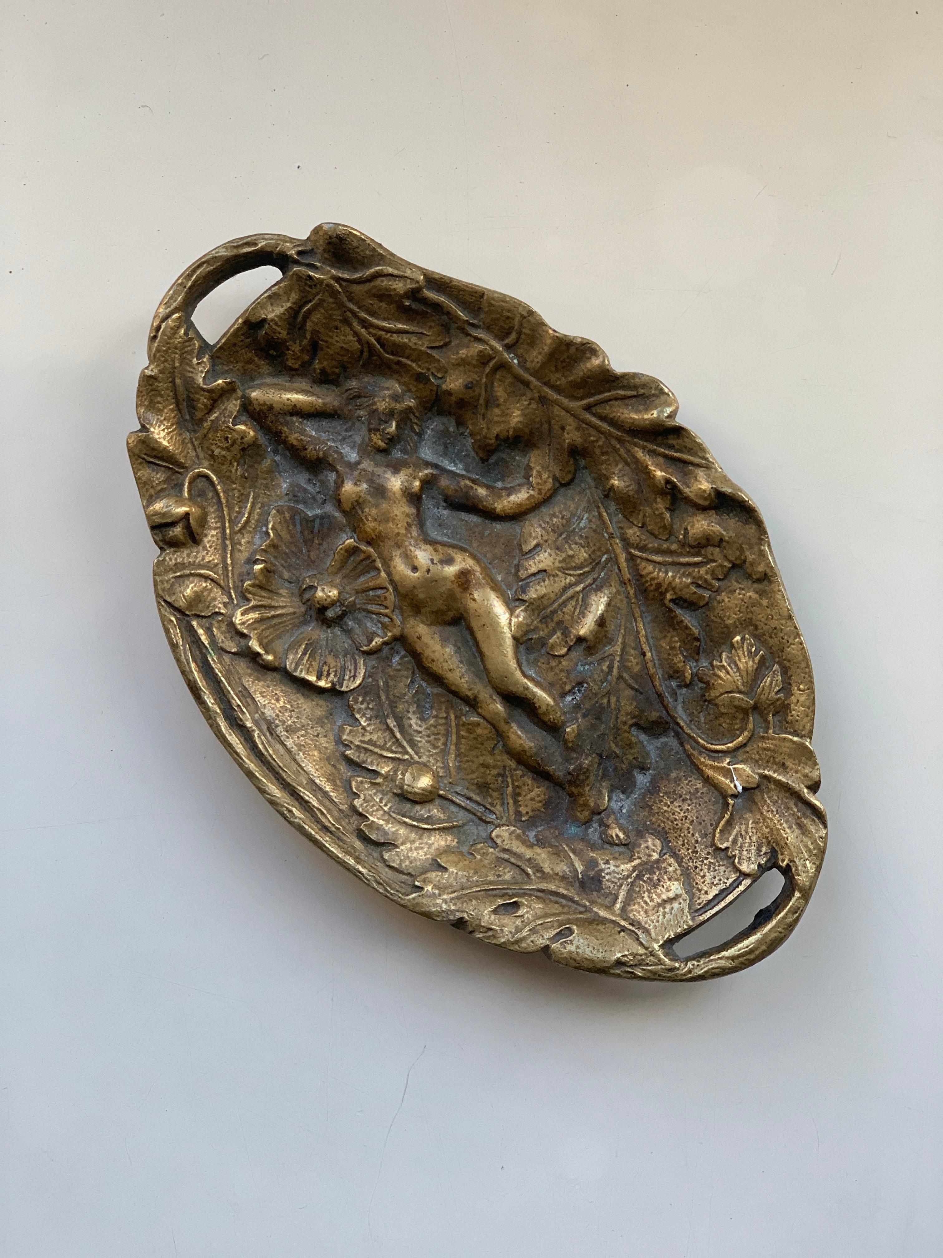 This bronze piece was used as pin tray also known as vide poche where you place rings or any other small item on your dresser or any other area in the home.
This original gilt bronze piece has nice finish and finely detailed woman's body surrounded
