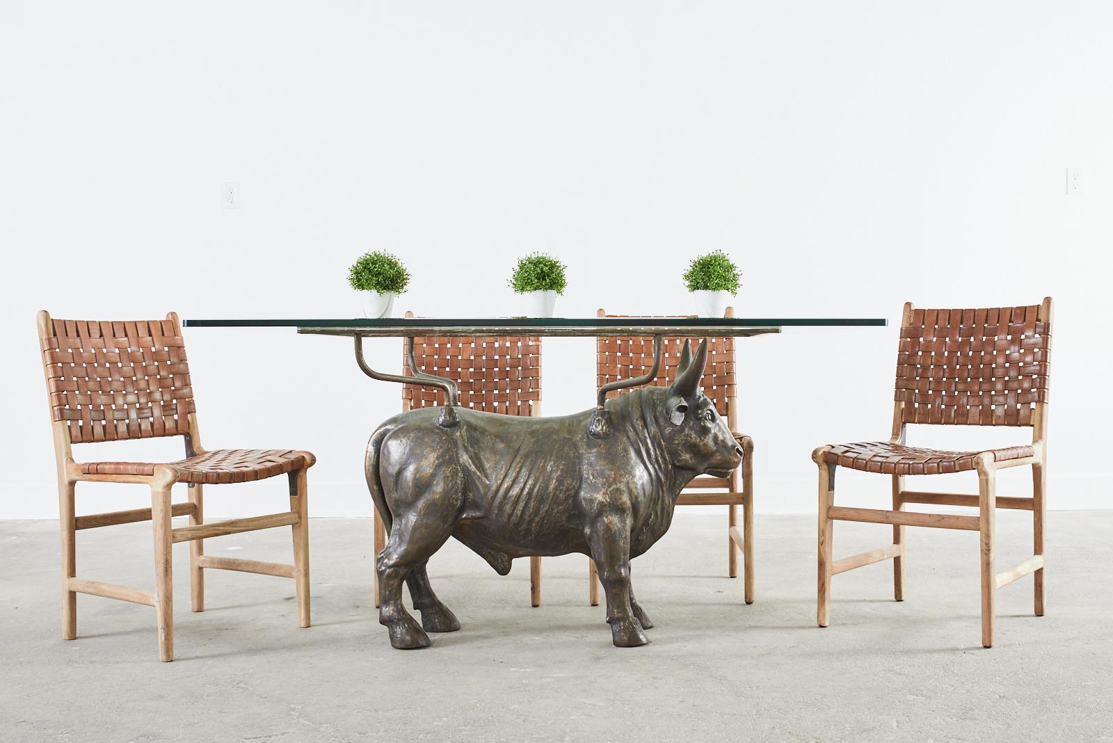 Amazing 19th century French cast iron bull dining table produced by Salin Foundry, Dammarie-Sur-Saulx. The solid bull features a bronzed patina and measures 37 inches wide by 30 inches high. The base glass support is 44.25 inches wide and 23.5