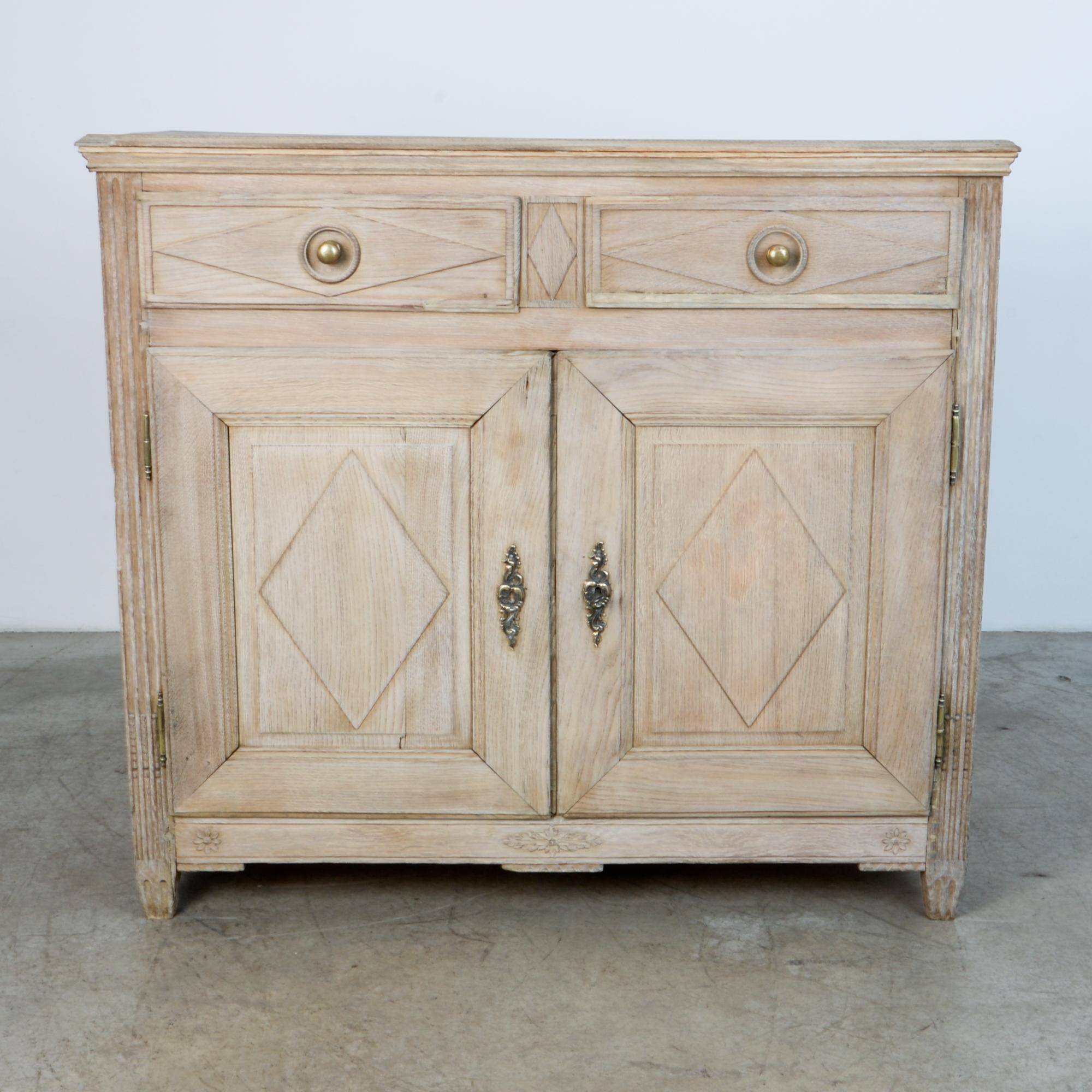 From circa 1860, a two-door and drawer cabinet in oak. A distinctly country style approach typifies the casual yet refined aesthetic of the French countryside. A beautiful rustic finish shows evidence of wear. The seasoning of time enhances the